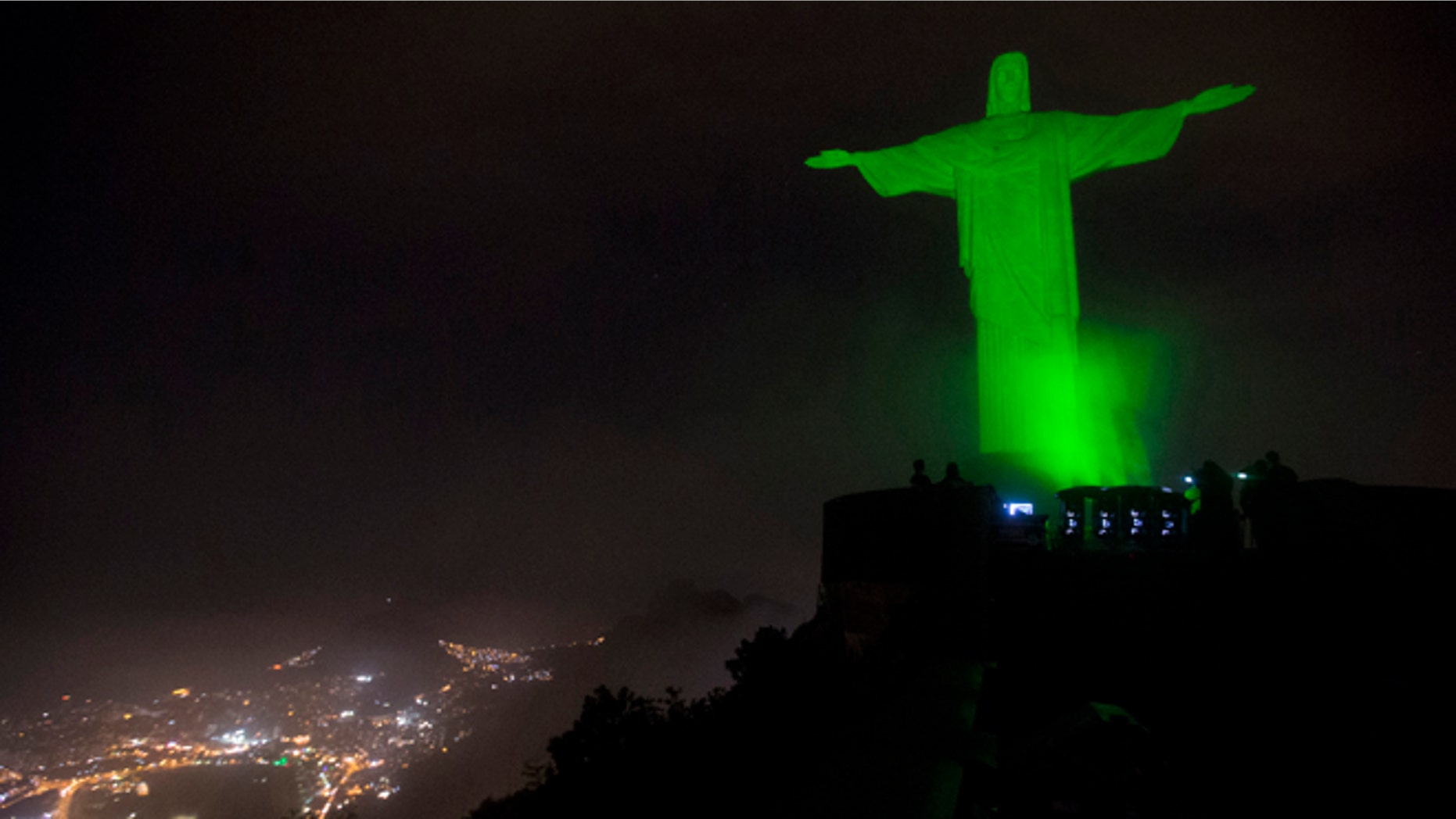The Christ the Redeemer statue is lit up in green as a symbolic warning of the dangers of climate change, in Rio de Janeiro, Brazil, Thursday, Sept. 18, 2014. This event is in support of the Global Peoples Climate March, scheduled for the next Sunday, which is asking for solutions to combat global climate change, in advance of the United Nations Climate Summit to be held on September 23. (AP Photo/Silvia Izquierdo)