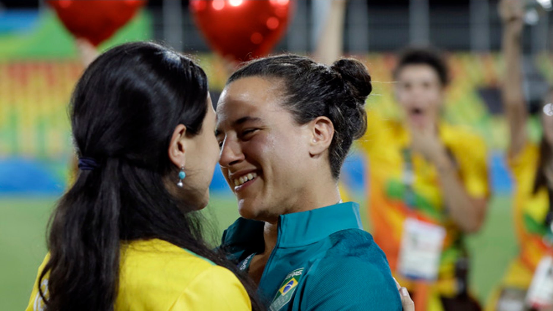 Brazil's Isadora Cerullo, right, shares a moment with her partner Marjorie Enya, after she was asked her to marry her, after the medal ceremony for the women's rugby sevens match at the Summer Olympics in Rio de Janeiro, Brazil, Monday, Aug. 8, 2016. (AP Photo/Themba Hadebe)