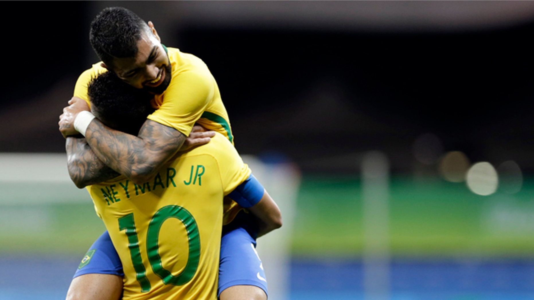 Brazil's Gabriel Barbosa celebrates with teammate Neymar after scoring his team's first goal during a group A match of the men' s Olympic football tournament between Brazil and Denmark in Salvador, Brazil, Wednesday Aug. 10, 2016.(AP Photo/Leo Correa)