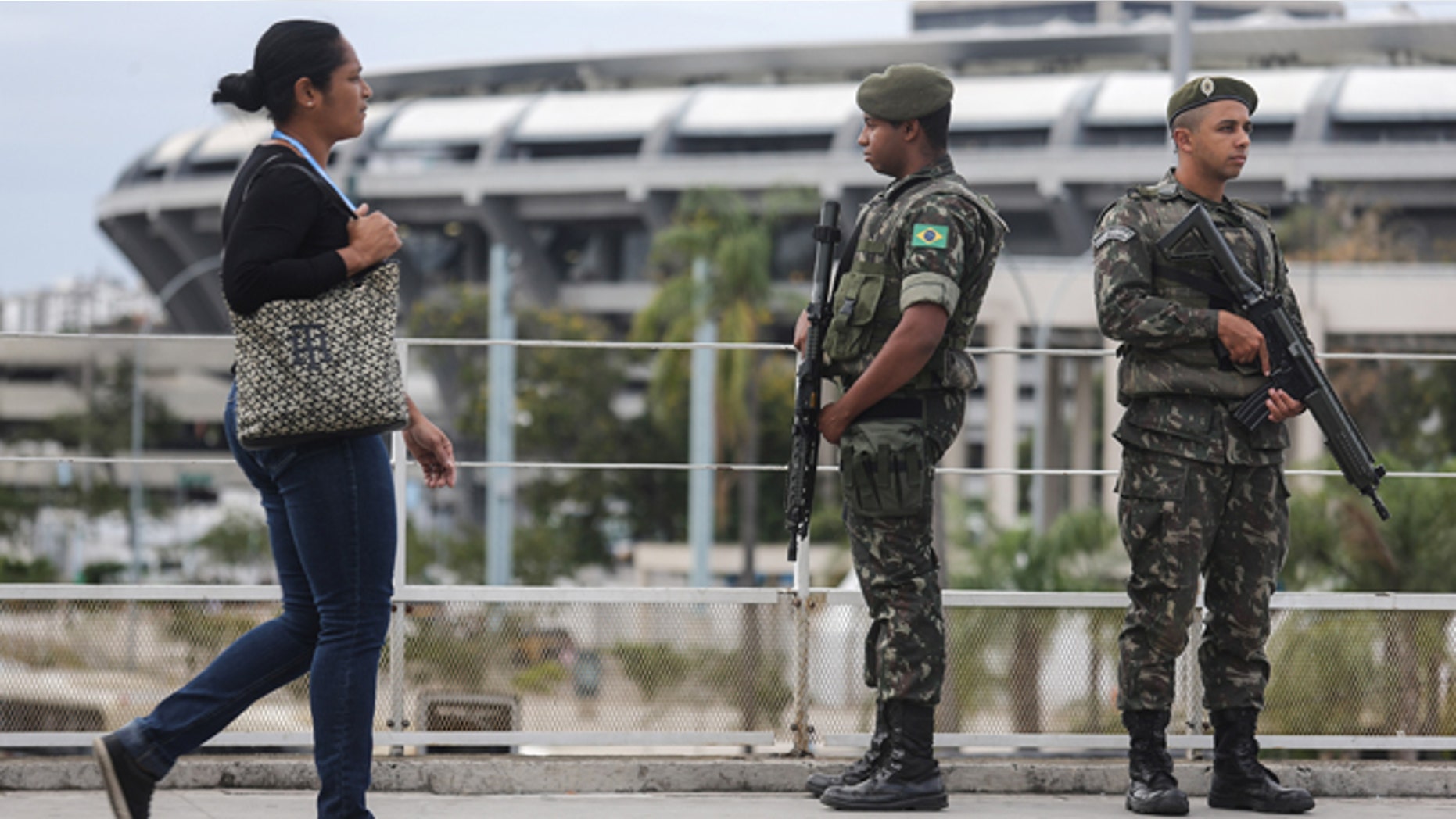 RIO DE JANEIRO, BRAZIL - JULY 17: Brazilian soldiers stand on patrol during a security rehearsal of the Rio 2016 Olympic Games opening ceremony outside Maracana stadium on July 17, 2016 in Rio de Janeiro, Brazil. Brazil announced July 15 it was bolstering security for the Olympics following the truck attack in Nice, France, which killed at least 84 people. The Olympics opening ceremony is August 5 at Maracana stadium. (Photo by Mario Tama/Getty Images)