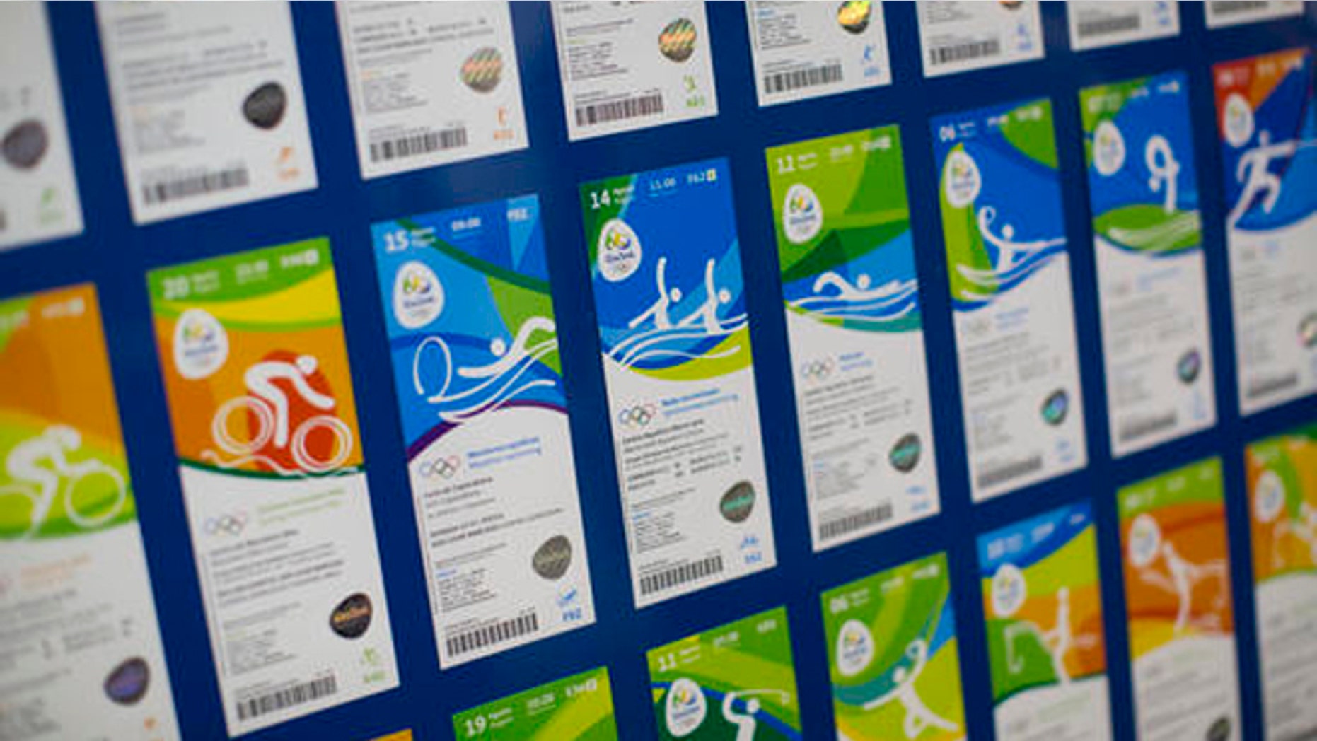 FILE - This May 20, 2016 file photo shows the presentation of the new design of Olympic tickets at Rio Olympic headquarters in Rio de Janeiro, Brazil. Olympic organizers say they want to return about $3 million in ticket refunds to people who returned their tickets. They say they have the money, but are having trouble paying people back due to missing bank details, etc. According to organizers, about 90 percent of refunds have already been made. (AP Photo/Felipe Dana, File)