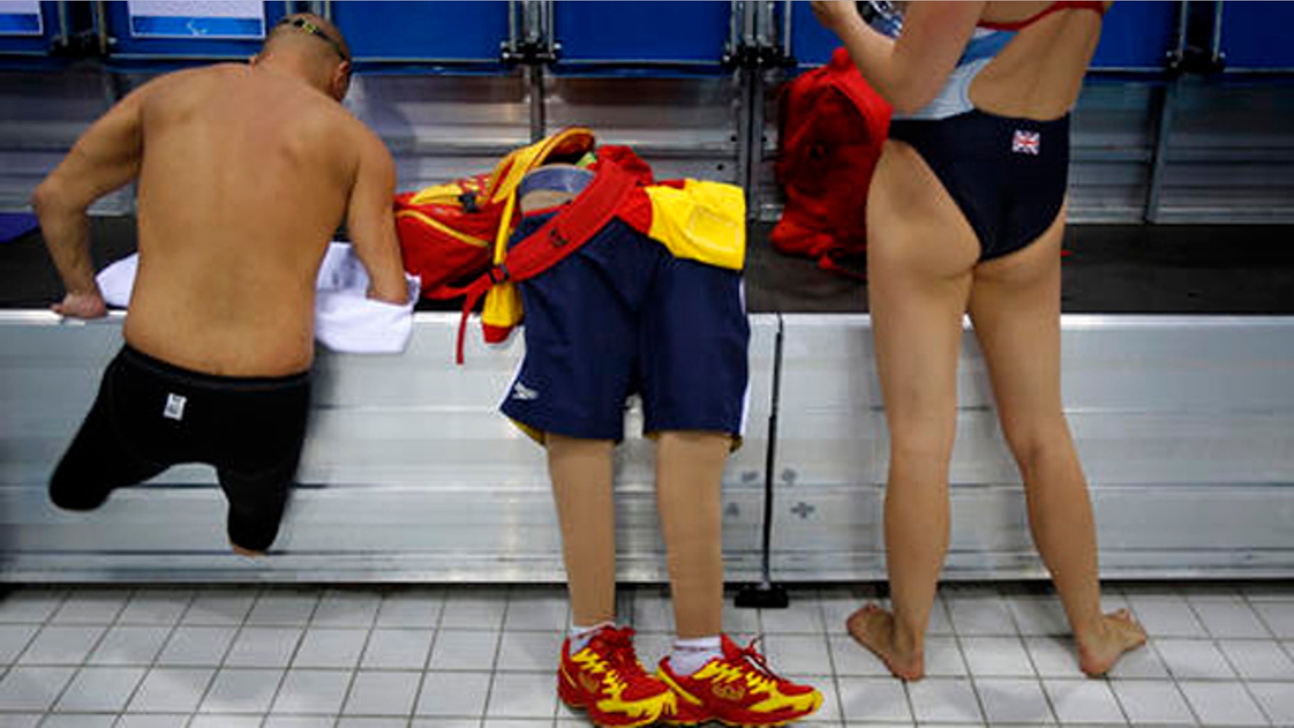 FILE - In this Aug. 31, 2012 file photo, Spain's Xabi Torres jumps next to his prosthesis as he leaves the swimming pool after training ahead of the competition at the 2012 Paralympics Olympics in London. The countdown clock for the Paralympic Games in Rio reaches 100 days on Monday with about 4,300 athletes participating, far fewer than the 10,500 in the Olympics. The Paralympic Games open Sept. 7.(AP Photo/Emilio Morenatti, File)