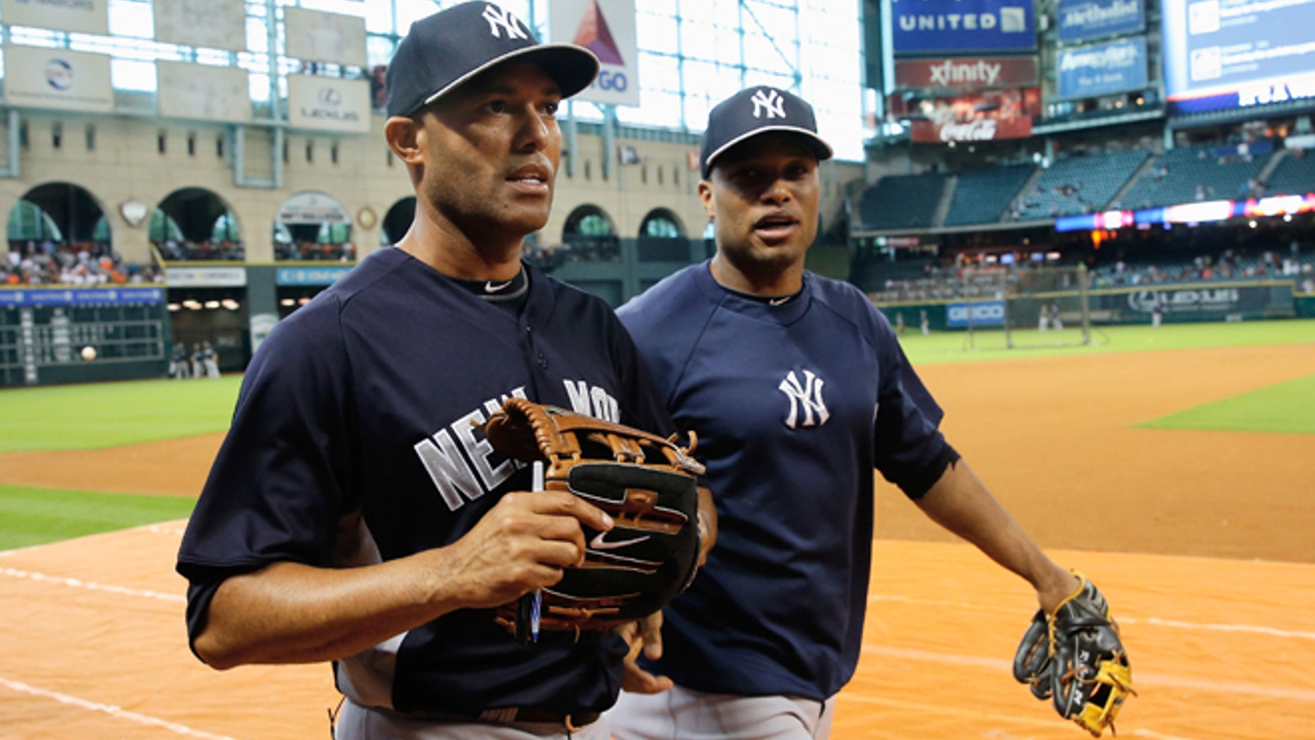 HOUSTON, TX - SEPTEMBER 28: Mariano Rivera #42 and Robinson Cano #24 of the New York Yankees walk on the field before the game against the Houston Astros at Minute Maid Park on September 28, 2013 in Houston, Texas. (Photo by Scott Halleran/Getty Images)