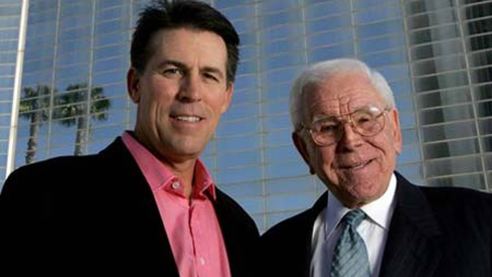 FILE: Robert A. Schuller, left, poses for a photo with his father, Robert H. Schuller, outside the Crystal Cathedral.