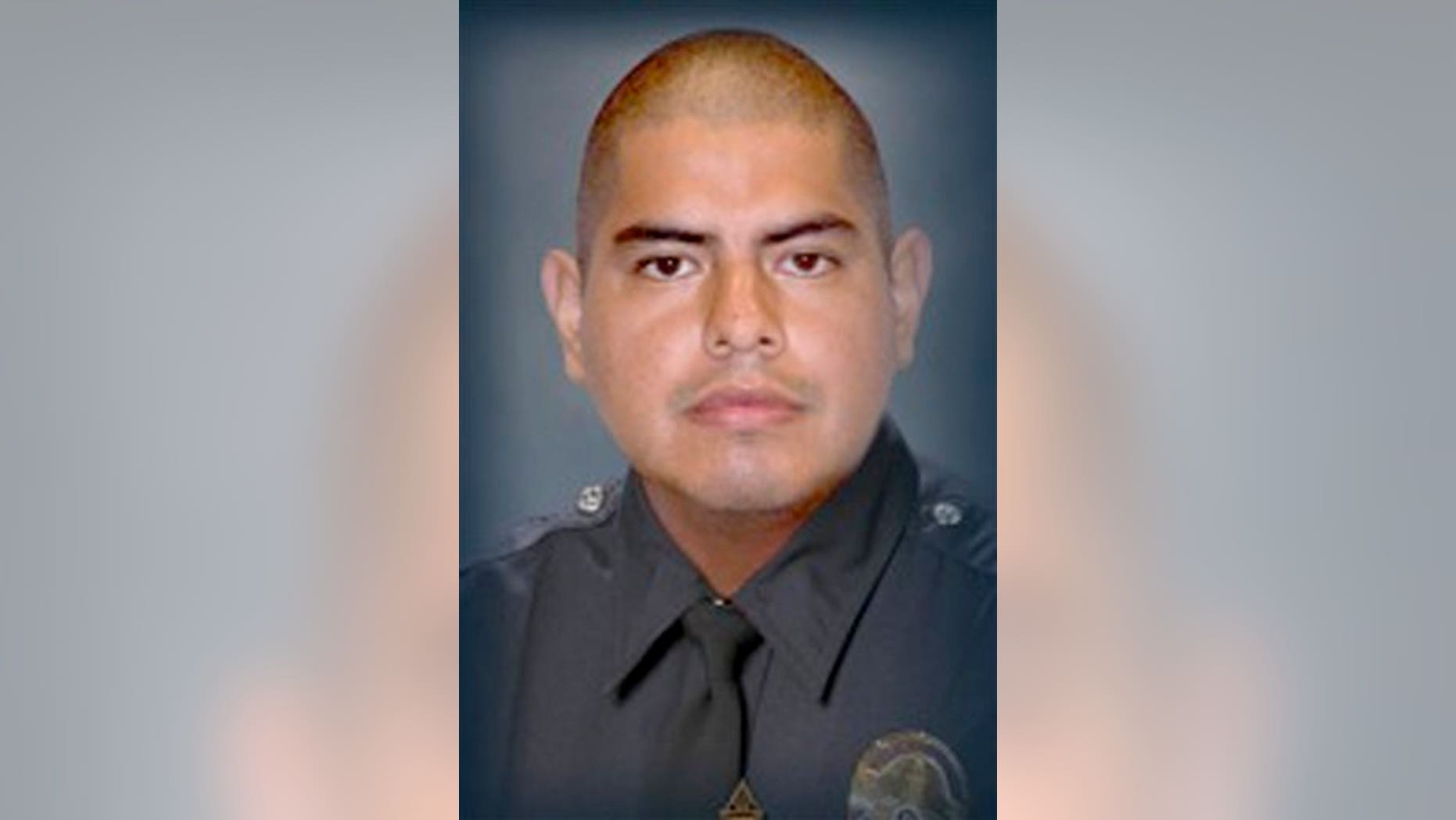 This image provided by the Los Angeles Police Department shows Officer Roberto C. Sanchez, who died Saturday May 3, 2014, at a Los Angeles hospital after the patrol car he was driving was broadsided by an SUV in the Harbor City area. The squad car was so mangled that Sanchez's partner had to call for help on his personal cellphone because the police radio wasn't working. (AP Photo/LAPD)