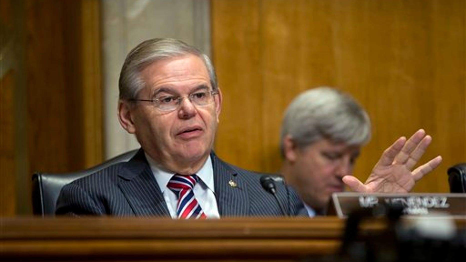 FILE - In this Jan. 9, 2014, file photo, Senate Foreign Relations Committee Chairman Sen. Robert Menendez, D-N.J., asks questions at a hearing on Capitol Hill in Washington, Thursday, Jan. 9, 2014. Menendez paid a law firm $250,000 in December 2013 for legal costs related to Justice Department and Senate Ethics Committee investigations into his ties with a major campaign donor. The Democrat also has set up a legal trust to raise money as the investigations continue. (AP Photo/Pablo Martinez Monsivais, File)