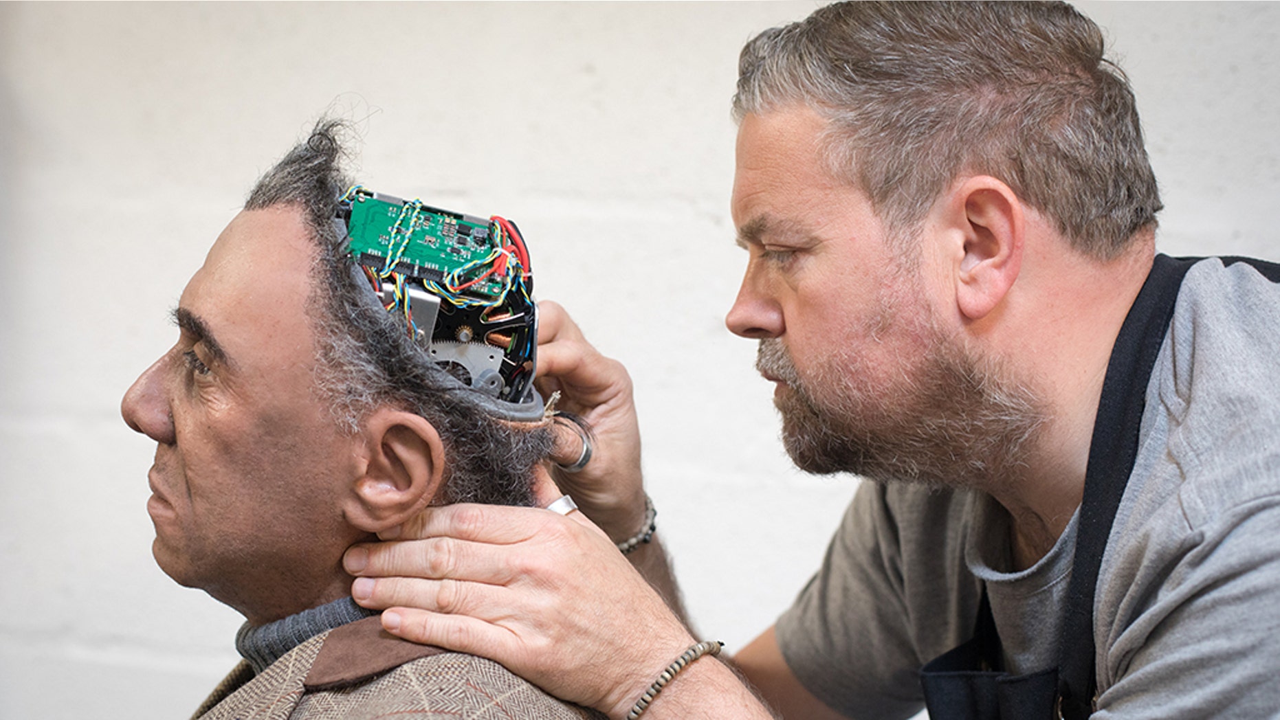 PENRYN, ENGLAND - MAY 09: Engineered Arts prosthetic expert Mike Humphrey checks on Fred a recently completed Mesmer robot that was built at the company's headquarters in Penryn on May 9, 2018 in Cornwall, England. (Photo by Matt Cardy/Getty Images)
