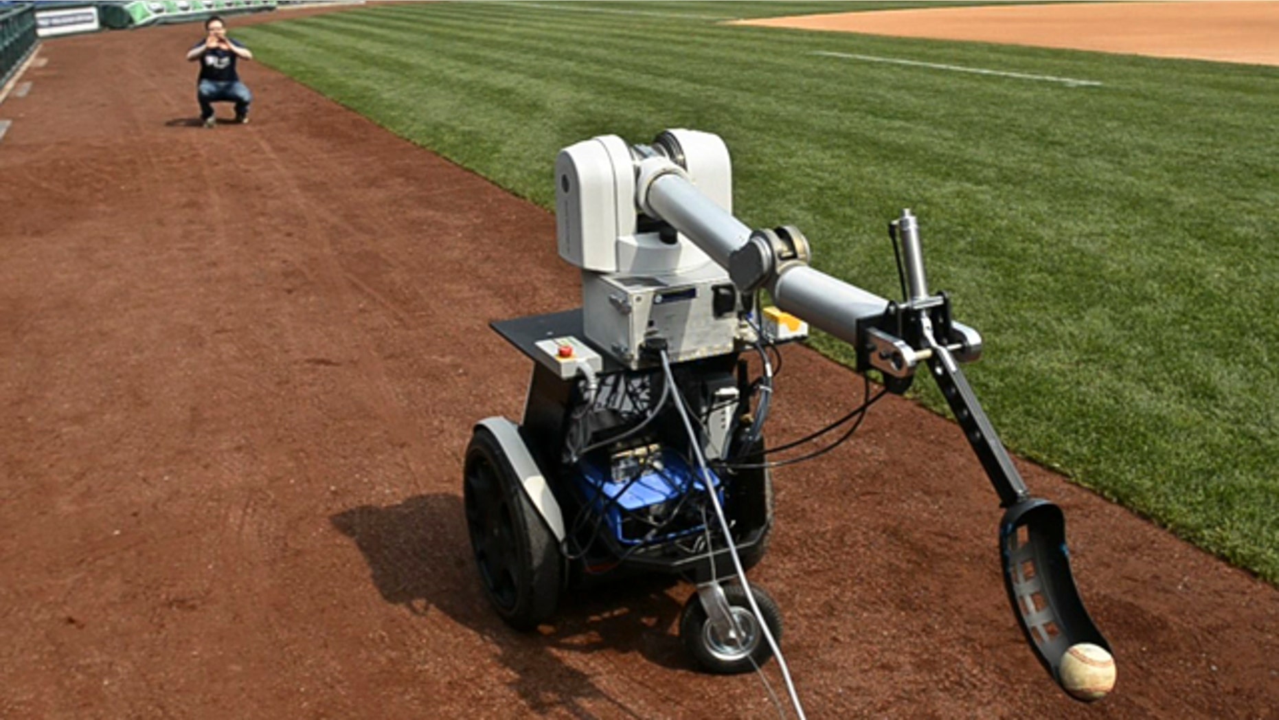Jamie Gewirtz waits for a robot to throw him a ball at Citizens Bank Park in Philadelphia, Monday April 18, 2011.