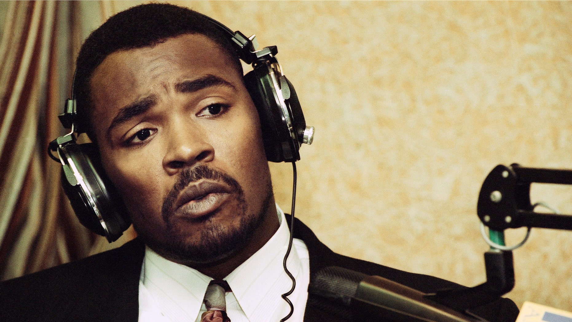 FILE - This July 20, 1993 file photo shows Rodney King speaking during an appearance on KFI-AM radio's "Bill Handel and Mark Whitlock" show in Los Angeles. King, the black motorist whose 1991 videotaped beating by Los Angeles police officers was the touchstone for one of the most destructive race riots in the nation's history, has died, his publicist said Sunday, June 17, 2012. He was 47. (AP Photo/Nick Ut, file)