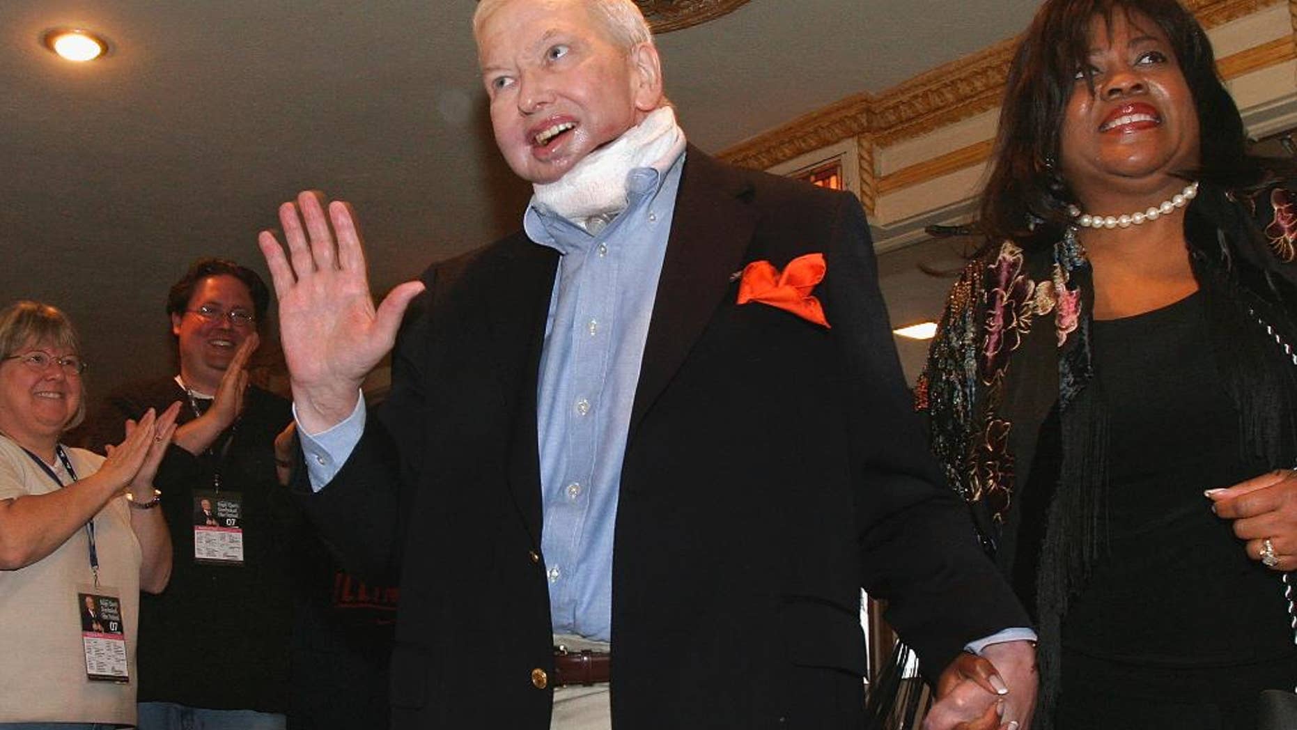 FILE - In this April 25, 2007, file photo, film critic Roger Ebert holds the hand of his wife, Chaz, as he enters the Virginia Theatre for his annual film festival in Champaign, Ill. Chaz Ebert and the University of Illinois announced Thursday, April 2, 2015, that efforts are underway to create a center named for late film critic in the College of Media at the school's Urbana-Champaign campus. Ebert died in 2013 after a long battle with cancer. (AP Photo/Seth Perlman, File)