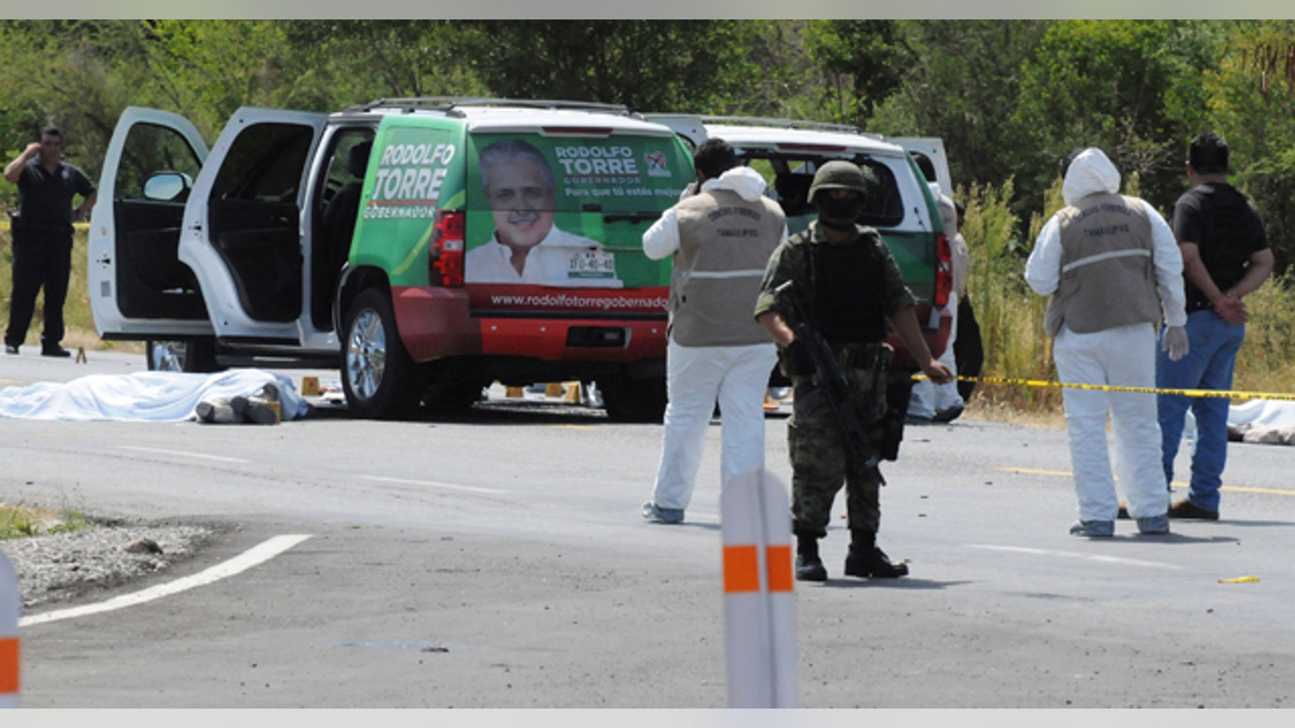 June 28: Army soldiers guard the crime scene as investigators work where the candidate for governor of the state of Tamaulipas, Rodolfo Torre, was ambushed by unidentified gunmen near the city of Ciudad Victoria, Mexico. (AP)