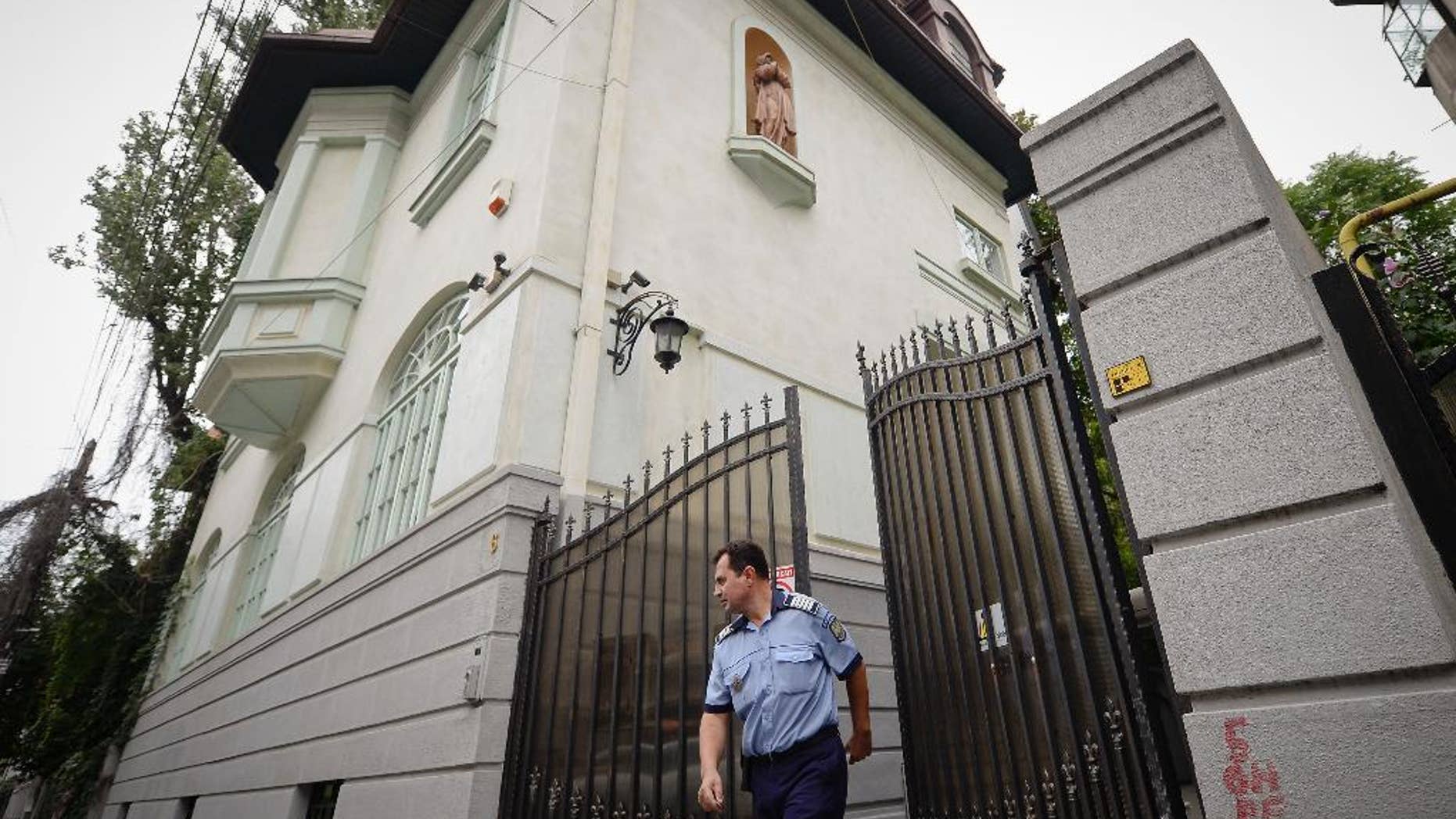 A police officer exits the gate of Romanian Prince Paul's house, in Bucharest, Romania, Thursday, Sept. 10, 2015. The prince's lawyer says his client, who is a grandson to Romania's King Carol II and a nephew to former King Michael, will pay 4.7 million pounds ($7.28 million) to a British Royalty Magazine editor, Marco Houston, following a court decision. (Octav Ganea, Mediafax via AP) ROMANIA OUT