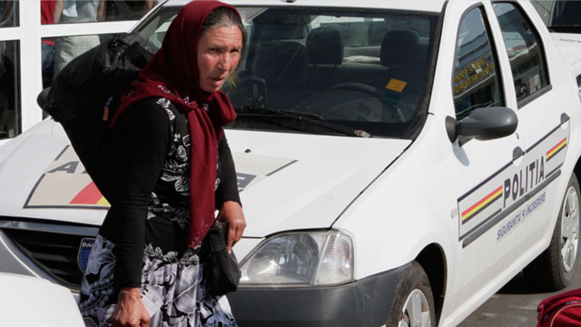 A Romanian Roma woman carries a bag after arriving from France in Bucharest, Romania, Thursday, Aug. 19, 2010. France expelled nearly 100 Gypsies, or Roma, to their native Romania on Thursday as part of a very public effort by conservative President Nicolas Sarkozy to dismantle Roma camps and sweep them out of the country. Those repatriated Thursday left "on a voluntary basis" and were given small sums of money _ euro300 ($386) for each adult and euro100 for children.