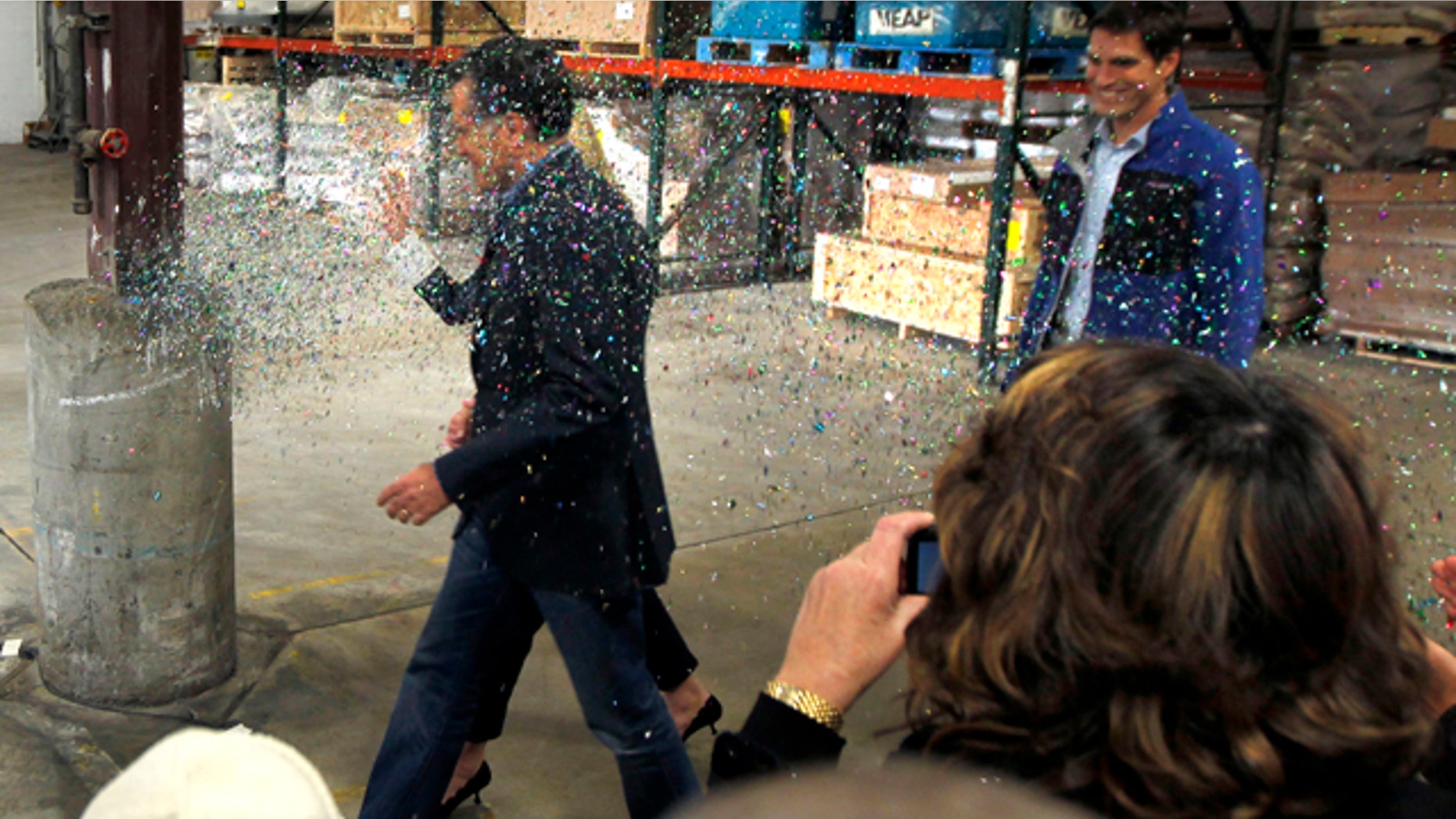 Feb. 1, 2012: Republican presidential candidate Mitt Romney is 'glitter bombed' as he walks to the stage in Eagan, Minn. A more recent attack ended in the alleged attacker's arrest.