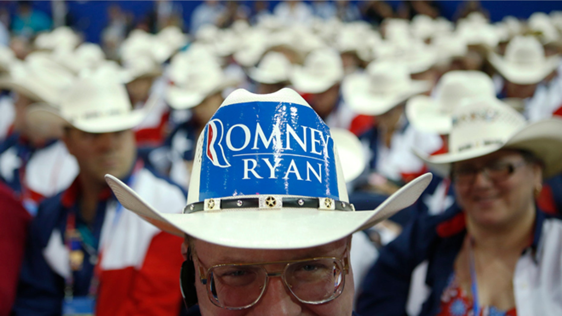 Texas delegate Clint Moore and the rest of Texas delegates fashion their cowboy hats at the Republican National Convention in Tampa, Fla., on Tuesday, Aug. 28, 2012. (AP Photo/Jae C. Hong)