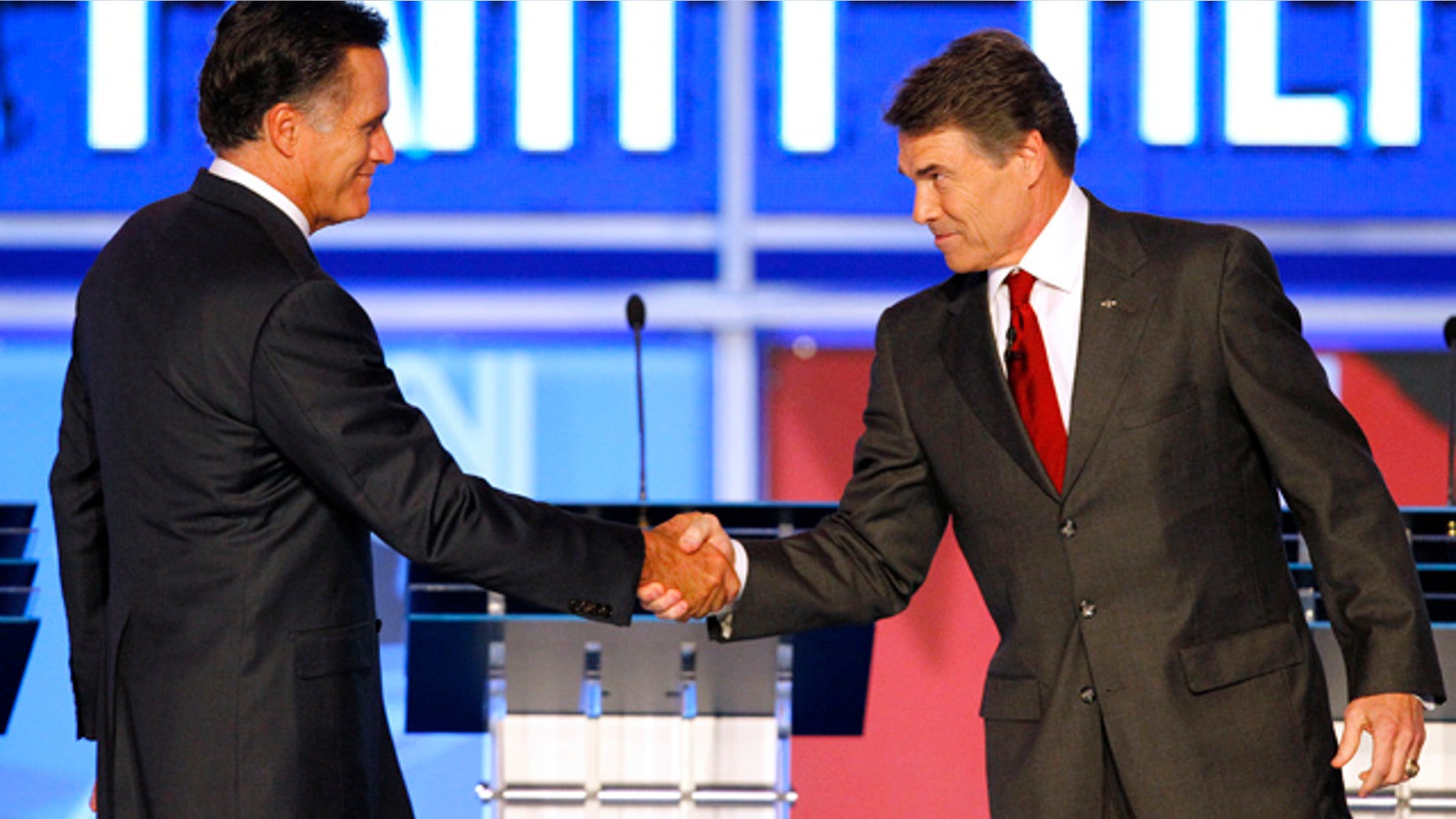 Sept. 12: Republican presidential candidates former Massachusetts Gov. Mitt Romney shakes hands with Texas Gov. Rick Perry before the start of a Republican debate in Tampa, Fla.