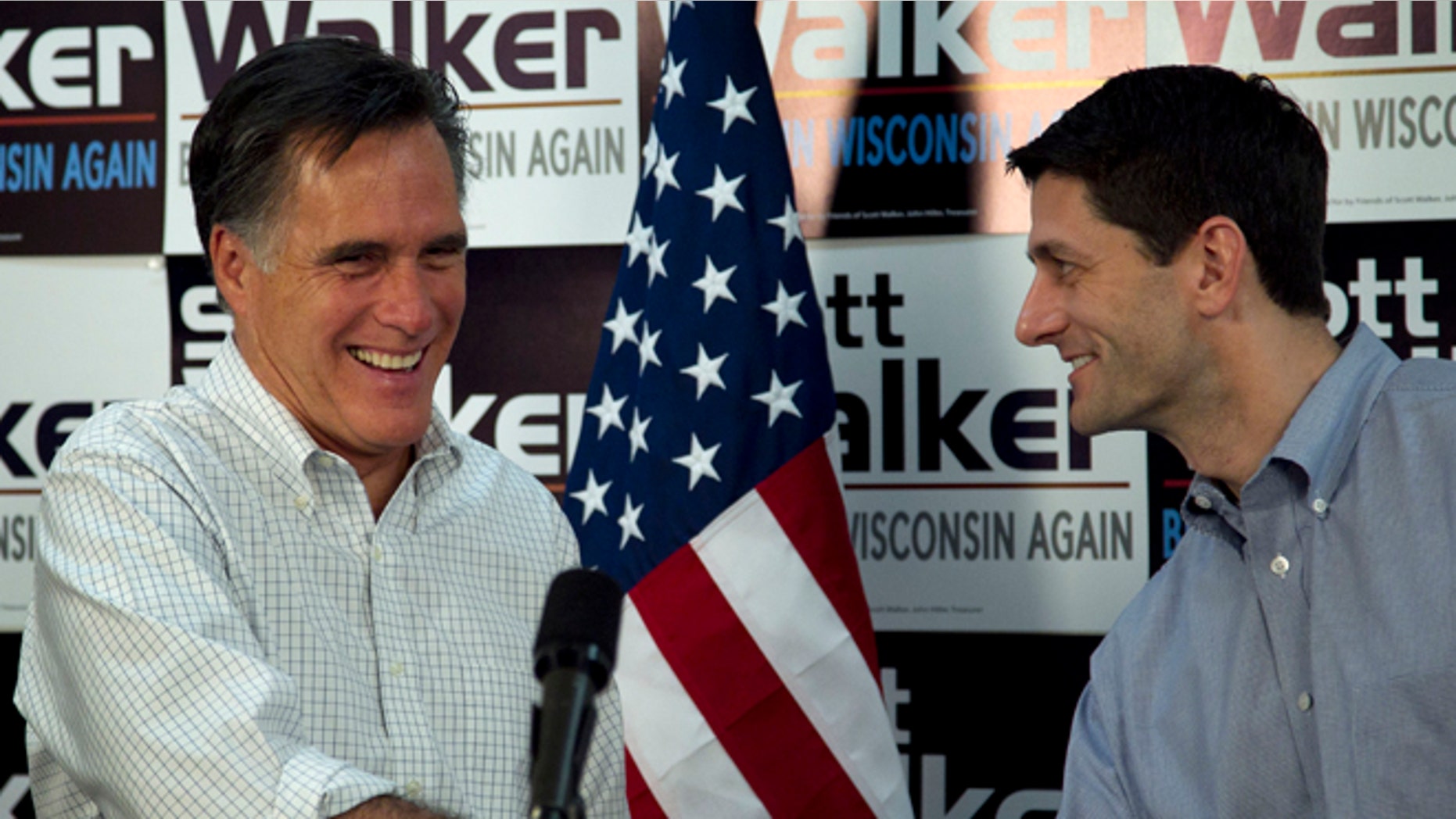 March 31, 2012: Republican presidential candidate, former Massachusetts Gov. Mitt Romney, left, shakes hands with U.S. Rep. Paul Ryan, R-Wis., Chairman of the House Budget Committee, right, before speaking with supporters of Wisconsin Republican Gov. Scott Walker at a phone bank during a campaign stop in Fitchburg, Wis.