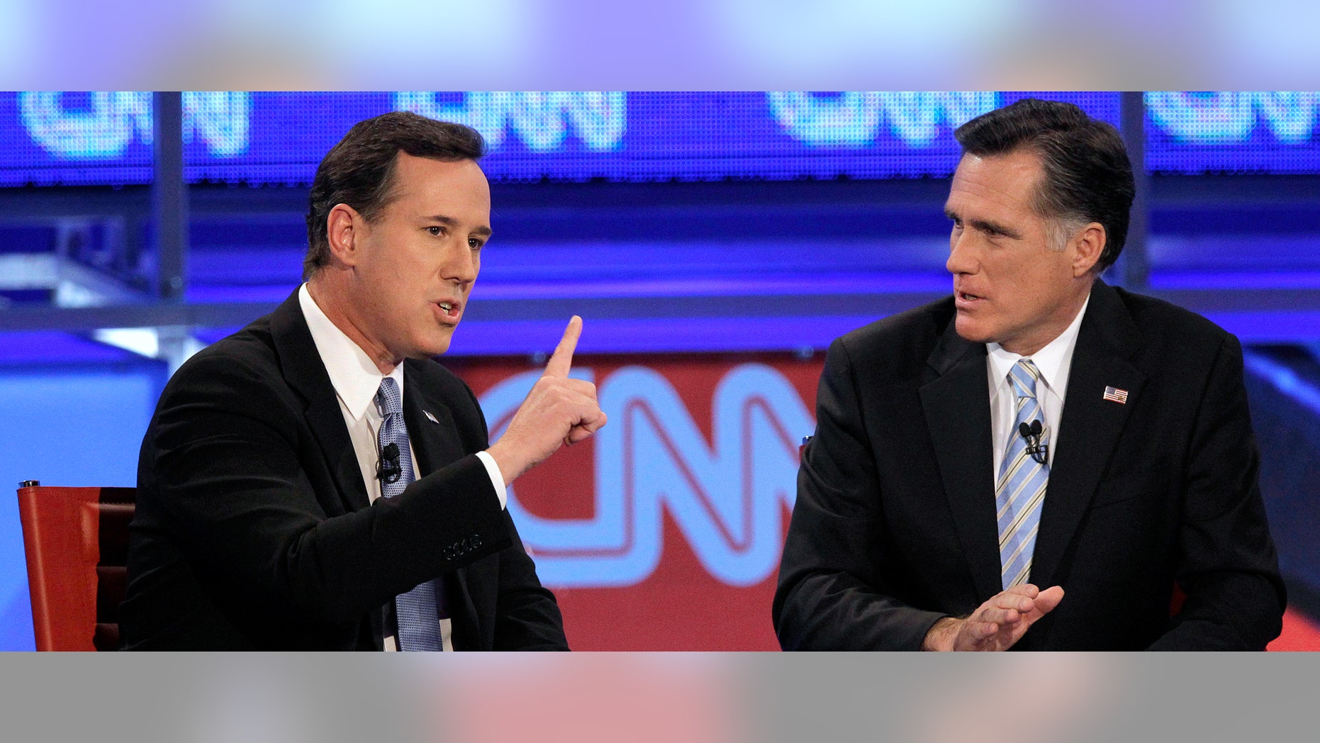 El aspirante presidencial republicano senador Rick Santorum, izquierda, habla mientras su rival el ex gobernador de Massachusetts Mitt Romney escucha durante un debate presidencial televisado el mièrcoles, 22 de febrero del 2012. (Foto AP/Jae C. Hong)