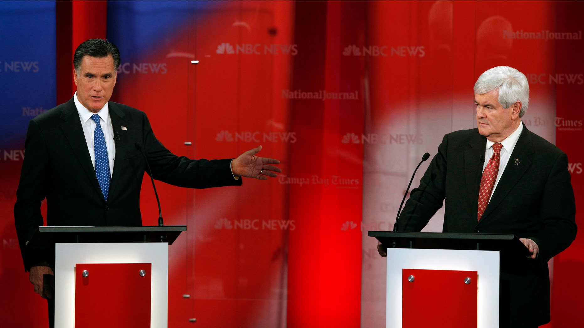 Republican presidential candidate, former Massachusetts Gov. Mitt Romney, gestures to former House Speaker Newt Gingrich during a Republican presidential debate Monday, Jan. 23, 2012, at the University of South Florida in Tampa, Fla. (AP Photo/Paul Sancya)
