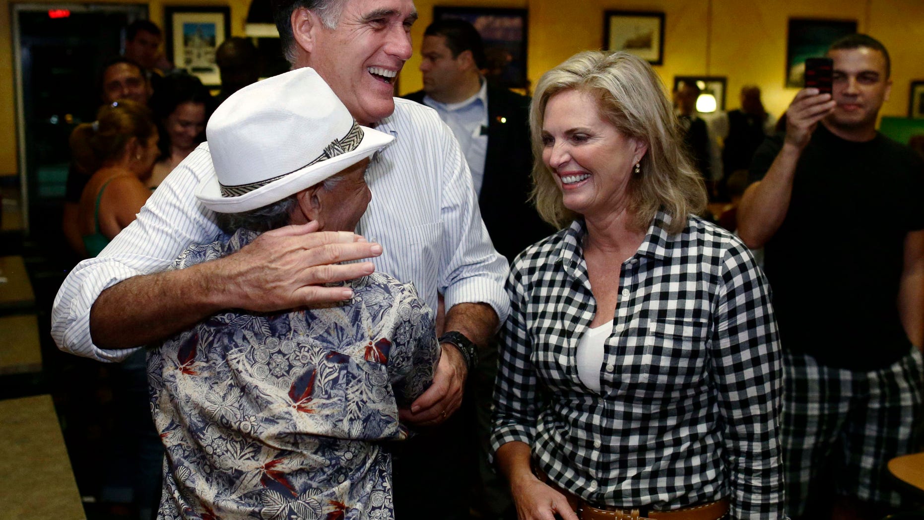 Oct. 5, 2012: Mitt Romney gets a hug from a patron as he campaigns with wife Ann during an unscheduled stop at La Teresita, a Cuban restaurant, in Tampa, Fla.