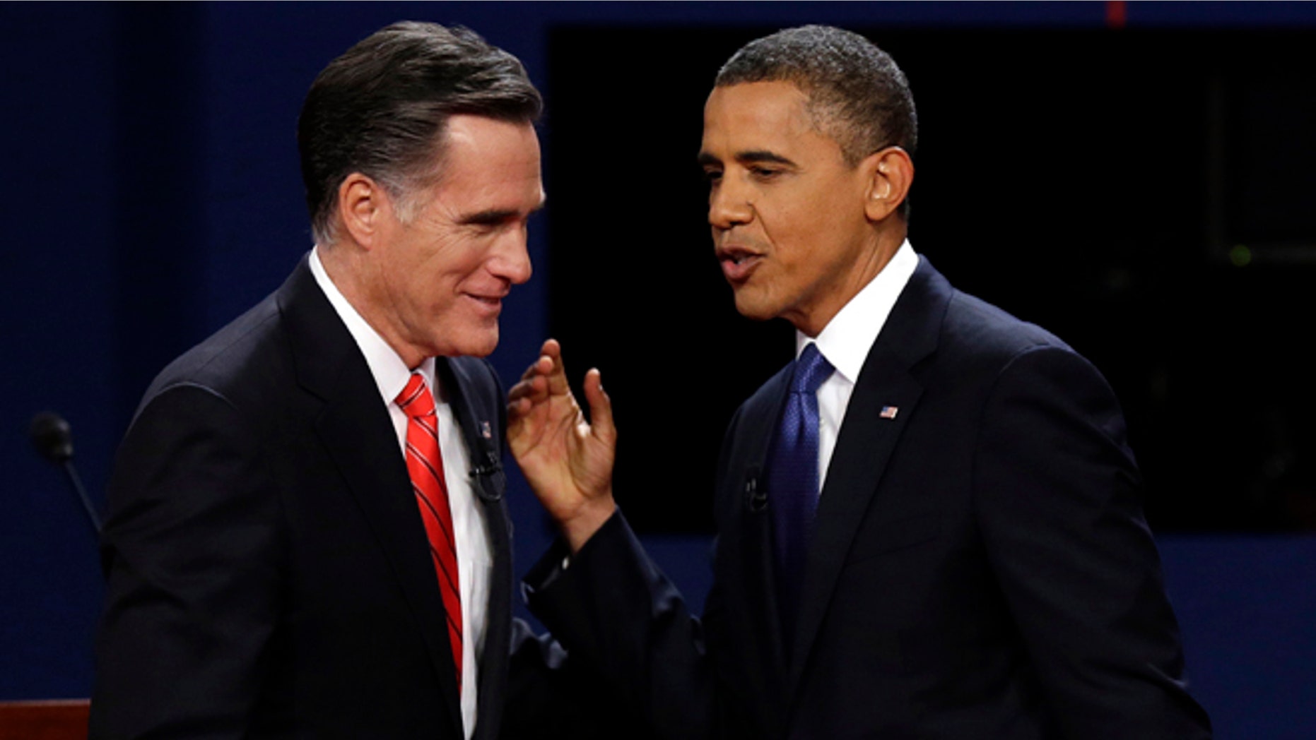 FILE: Oct. 3, 2012: Mitt Romney and President Obama talk after their debate at the University of Denver, in Denver.