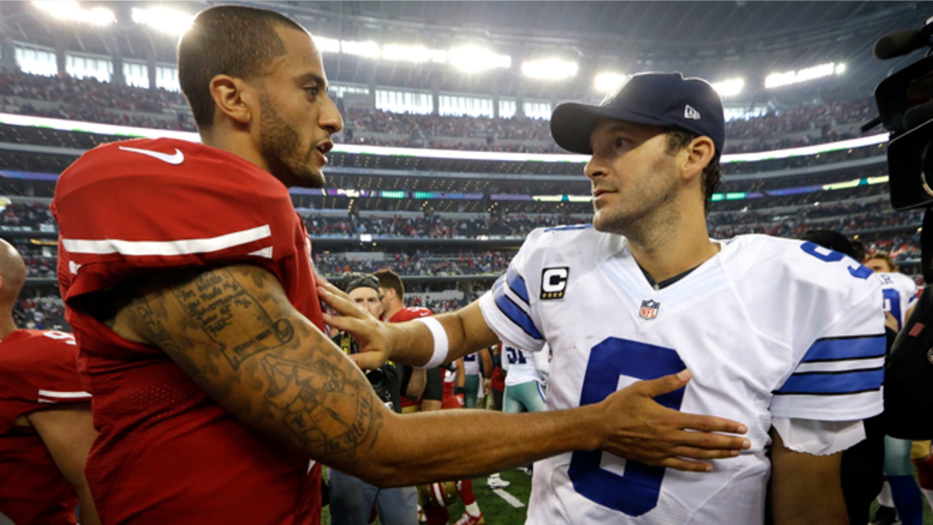 Colin Kaepernick and Tony Romo after their NFL football game, Sunday, Sept. 7, 2014, in Arlington, Texas.