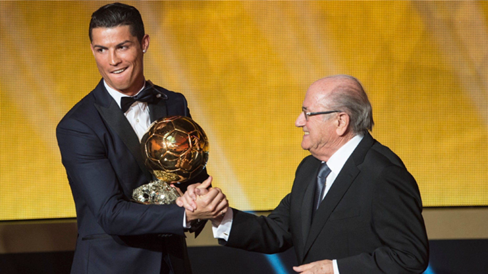 Cristiano Ronaldo congratulated by FIFA President Joseph Blatter the 2014 prize at the FIFA Ballon d'Or.