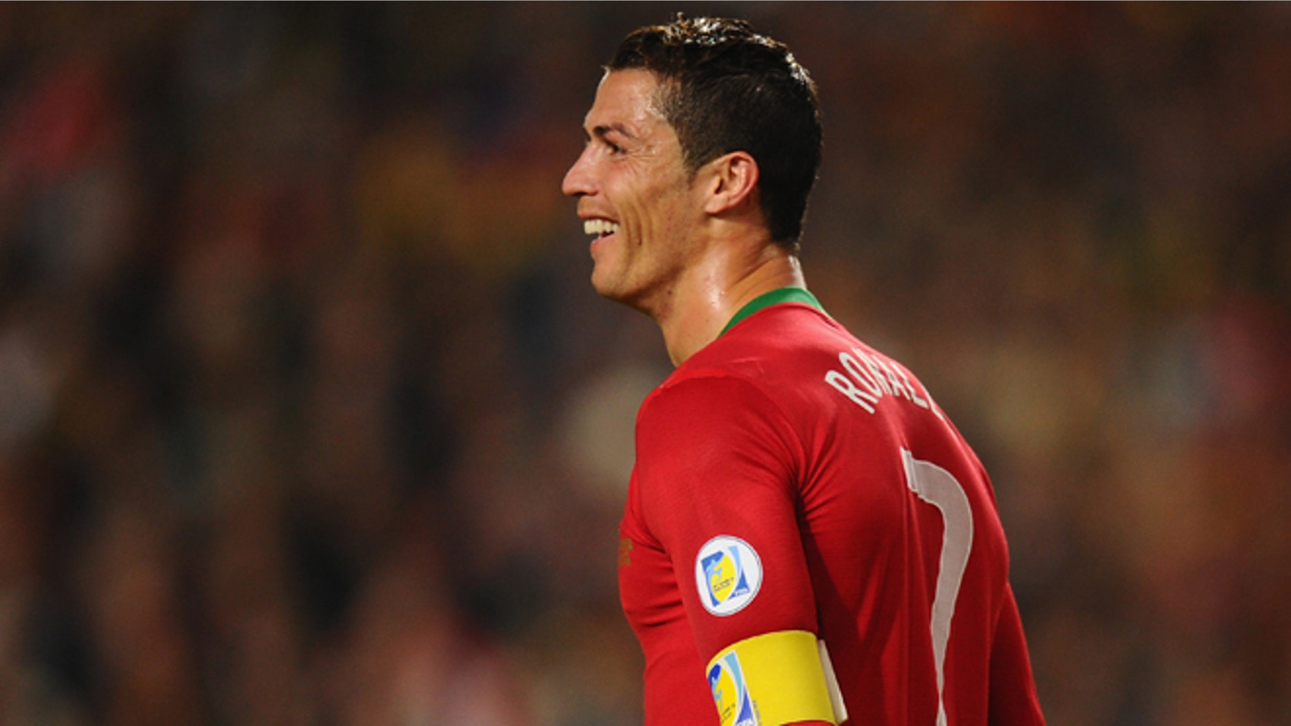 LISBON, PORTUGAL - NOVEMBER 15: Cristiano Ronaldo of Portugal smiles after scoring during the National Anthems ahead of the FIFA 2014 World Cup Qualifier Play-off First Leg between Portugal and Sweden at Estadio da Luz on November 15, 2013 in Lisbon, Portugal. (Photo by Mike Hewitt/Getty Images)