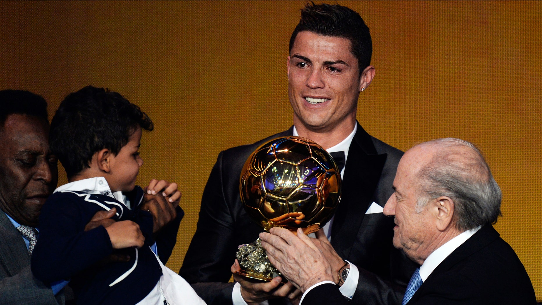 Cristiano Ronaldo of Portugal, center, is awarded the prize for the FIFA Men's soccer player of the year 2013 by FIFA President Sepp Blatter, right, and Pelé, left, at the FIFA Ballon d'Or 2013 gala at the Kongresshaus in Zurich, Switzerland, Monday, Jan. 13, 2014. (AP Photo, Keystone/Steffen Schmidt)