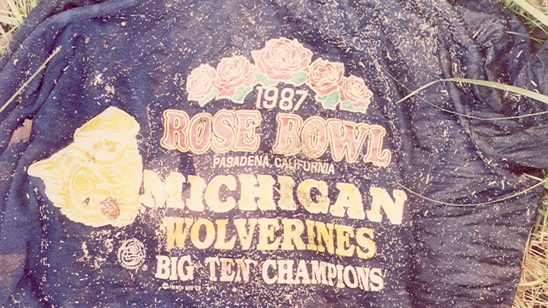 The victim was found wearing this dark blue, short sleeve "1987 Rose Bowl" t-shirt, size 1XL.