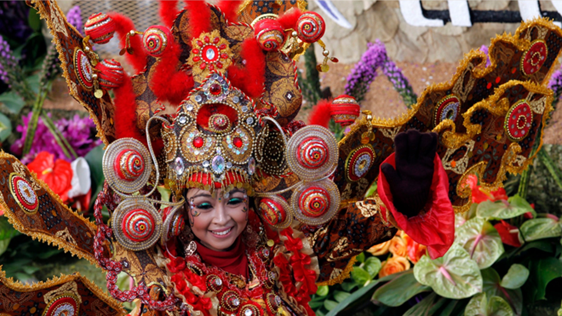 Jan. 1, 2013: A woman smiles from the float "Wonderful Indonesia" from the Ministry of Tourism and Creative Economies, Republic of Indonesia_the winner of the Presidents trophy for the most innovative use and presentation of flowers in the 124th Rose Parade in Pasadena, Calif.