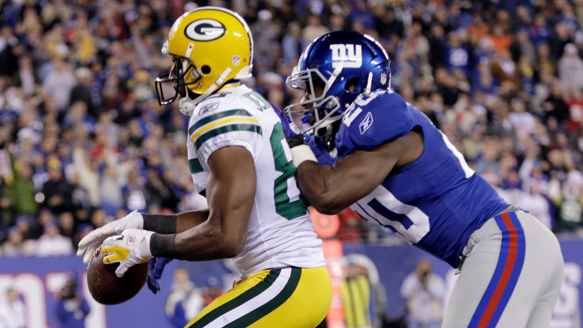Green Bay Packers' Greg Jennings (85) catches a pass as New York Giants' Prince Amukamara (20) defends during the third quarter of an NFL football game Sunday, Dec. 4, 2011, in East Rutherford, N.J. The play was ruled a touchdown. (AP Photo/Kathy Willens)