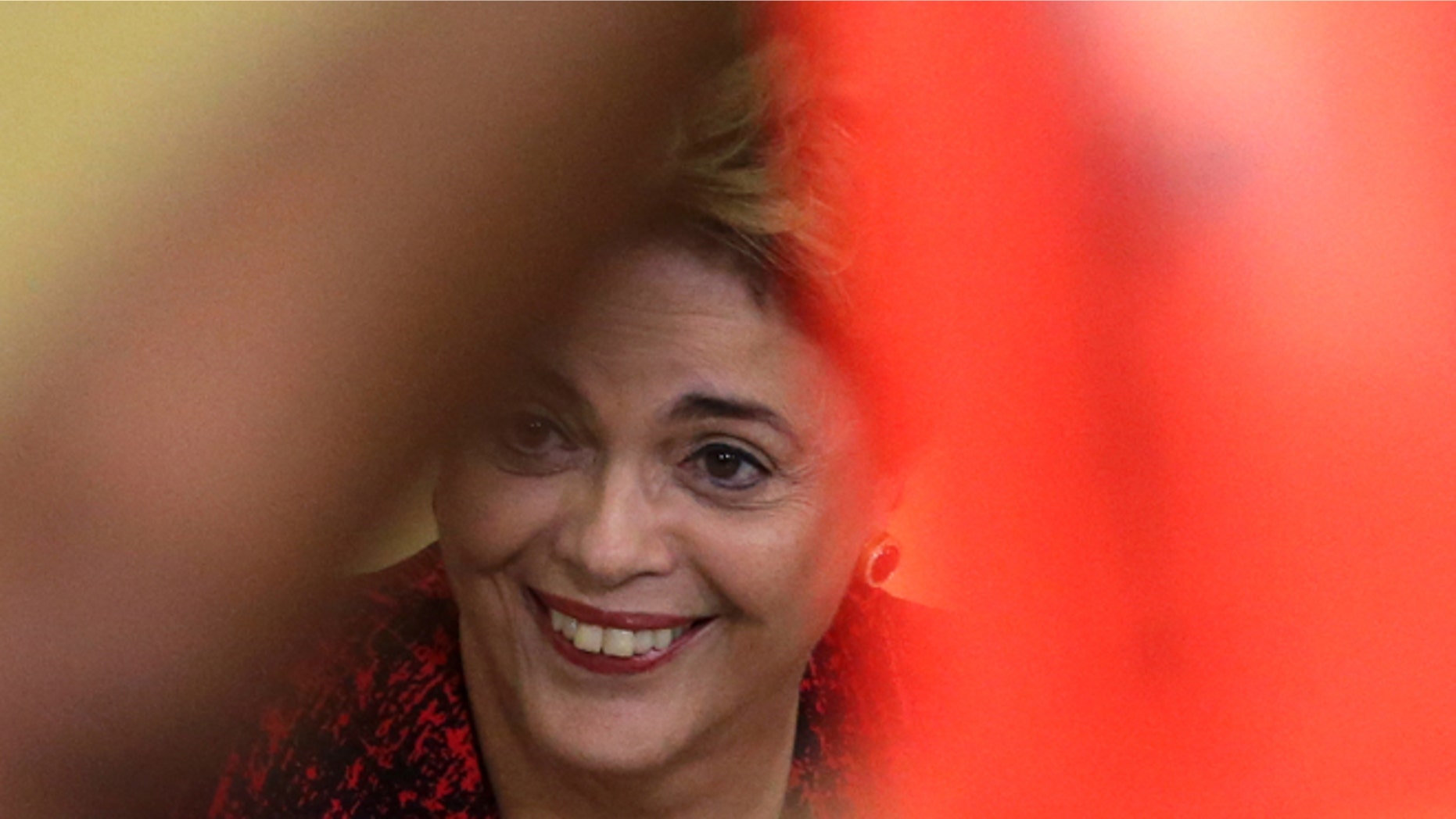 Brazil's President Dilma Rousseff smiles during a ceremony where she announced the opening of new federal universities at Planalto presidential palace in Brasilia, Brazil, Monday, May 9, 2016. The acting speaker of the lower house of Brazil's Congress on Monday annulled last month's vote on impeachment, delaying and complicating the process that was widely expected to see Rousseff suspended later this week. (AP Photo/Eraldo Peres)