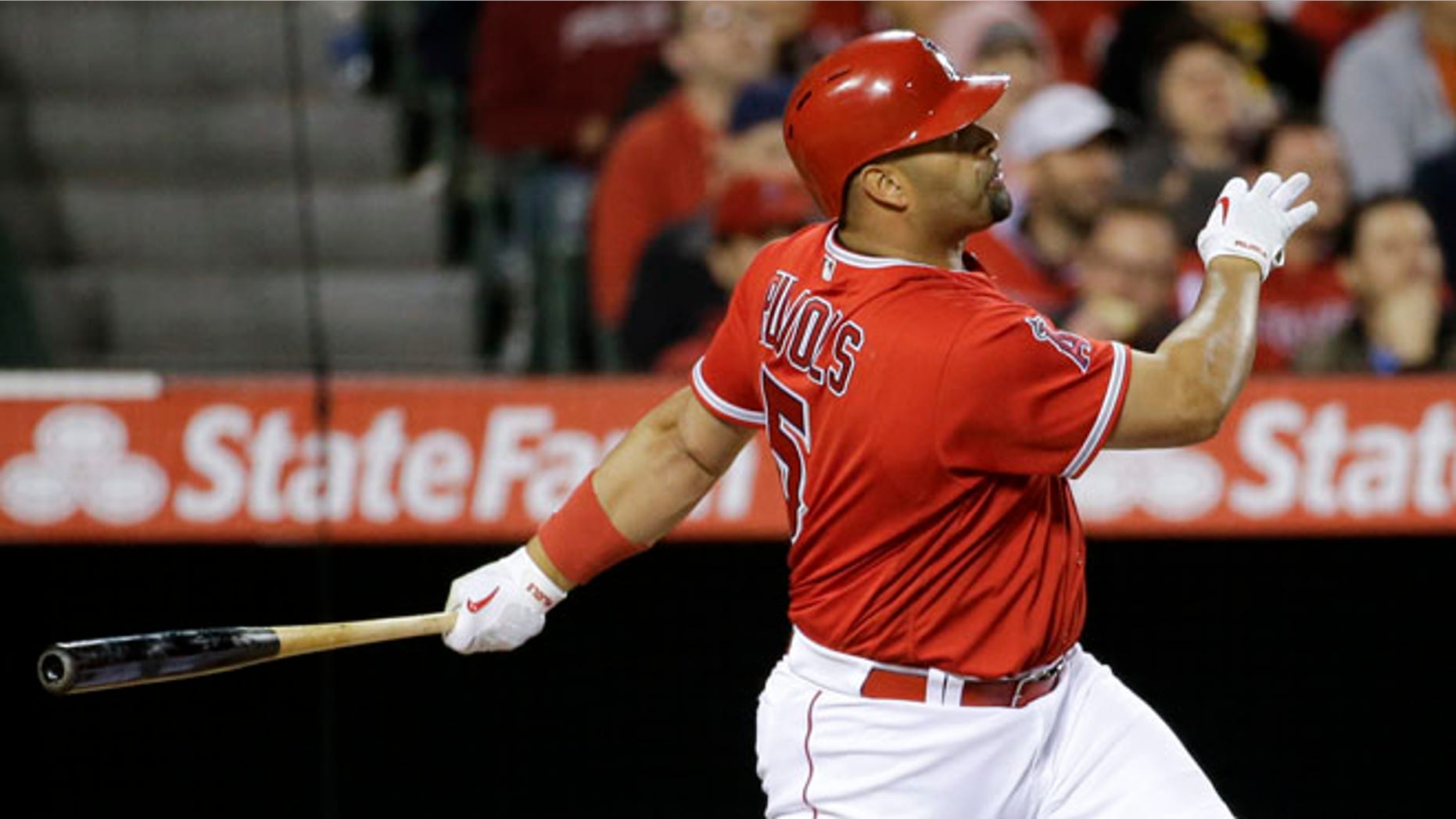 Los Angeles Angels' Albert Pujols watches his home run against the Kansas City Royals during the fifth inning of a baseball game in Anaheim, Calif., Monday, April 25, 2016. (AP Photo/Chris Carlson)