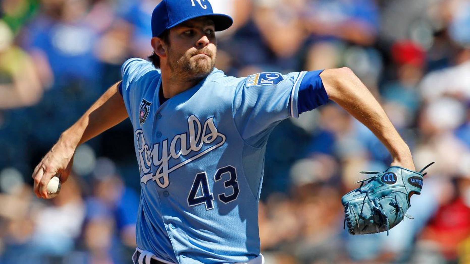 FILE - In this July 27, 2014, file photo, Kansas City Royals relief pitcher Aaron Crow throws to a batter in the ninth inning of a baseball game against the Cleveland Indians at Kauffman Stadium in Kansas City, Mo. The former first-round draft pick was traded Friday, Nov. 28, 2014, from the Royals to the Miami Marlins for left-hander Brian Flynn and right-hander Reid Redman. (AP Photo/Colin E. Braley, File)