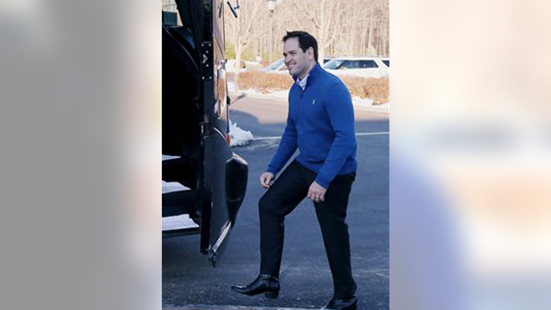 Republican presidential candidate Sen. Marco Rubio, R-Fla., steps into his campaign bus after a stop at the Atkinson Country Club, Sunday, Jan. 3, 2016, in Atkinson, N.H. (AP Photo/Mary Schwalm)