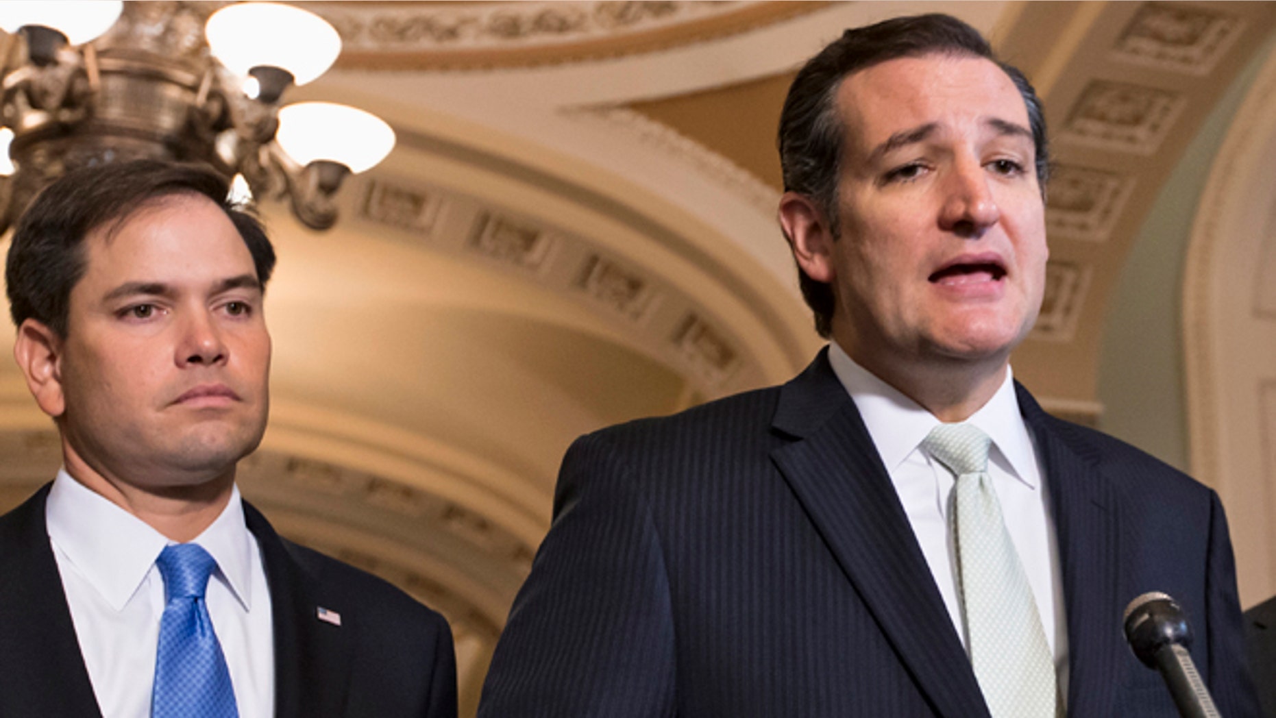 FILE - In this Sept. 27, 2013 file photo, Sen. Ted Cruz, R-Texas, right, accompanied by Sen. Marco Rubio, R-Fla., speaks on Capitol Hill in Washington. Republican presidential rivals Rubio and Cruz are backpedaling furiously as they try to outmaneuver each other on immigration. Rubio co-wrote a massive 2013 immigration bill that passed the Senate. He disavows it now, but Cruz wont stop talking about it. (AP Photo/J. Scott Applewhite, File)