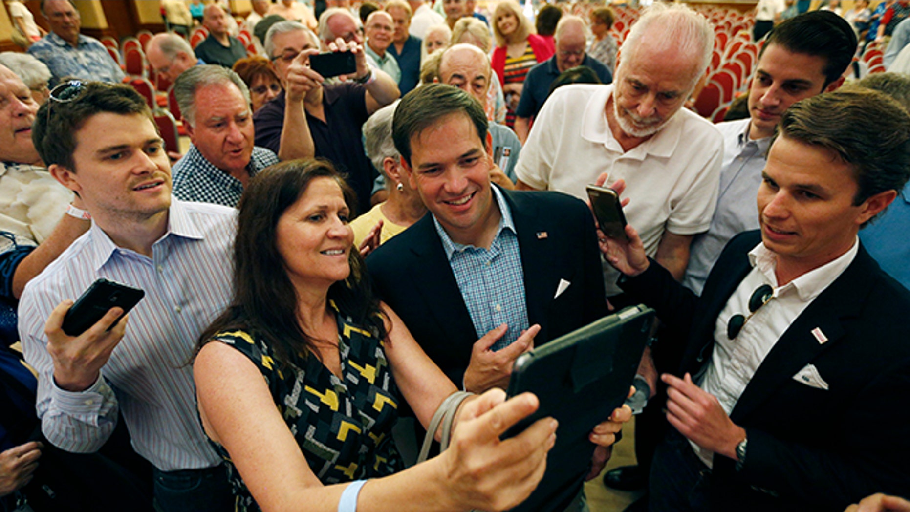Republican presidential candidate Sen. Marco Rubio, R-Fla., takes pictures with people during a campaign event Saturday, July 11, 2015, in Henderson, Nev. (AP Photo/John Locher)