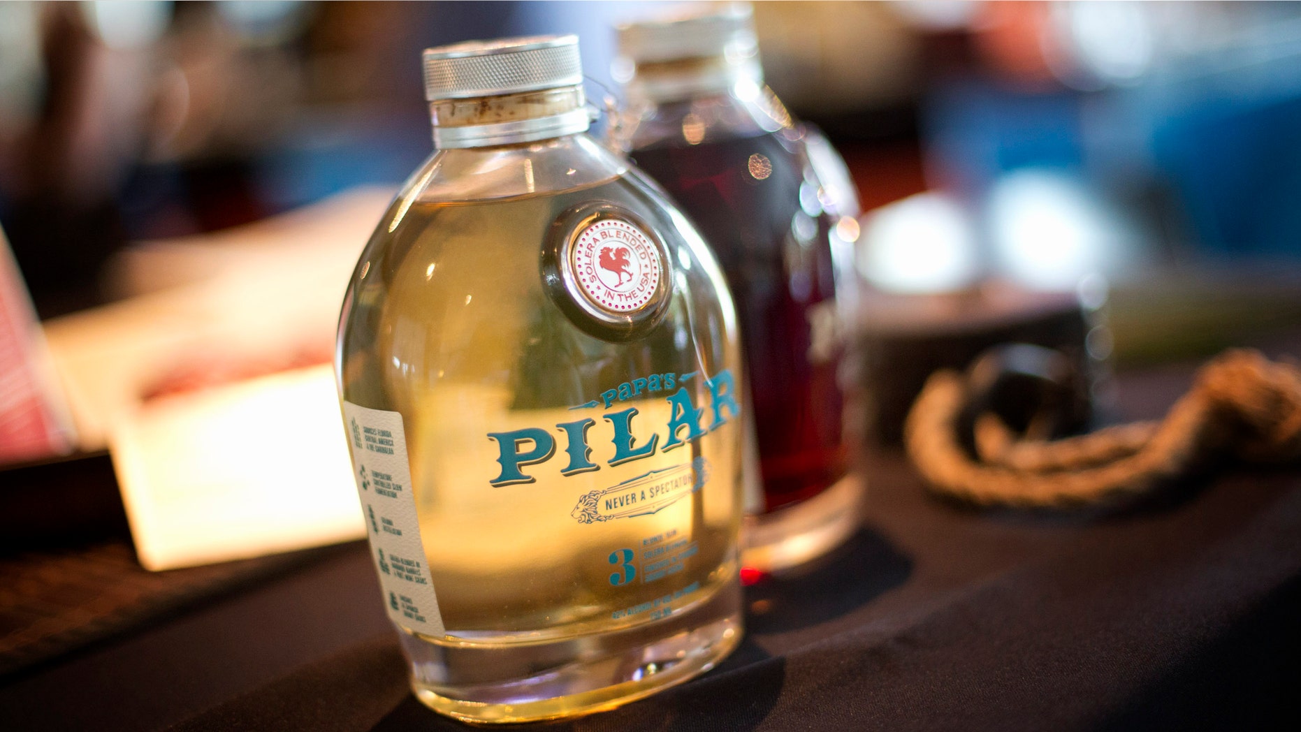 In this Wednesday, April 17, 2013 photo, two bottles of Papas Pilar Rum are on display at the Miami Rum Festival. The rum is being introduced at the festival to the general public. Rum: It's not just the alcohol that made you queasy in college. And it's not all the same. Thousands of people are expected to attend the weeklong festival that begins April 15 in Miami to sample more than 200 kinds of rum and discuss industry trends. (AP Photo/J Pat Carter)