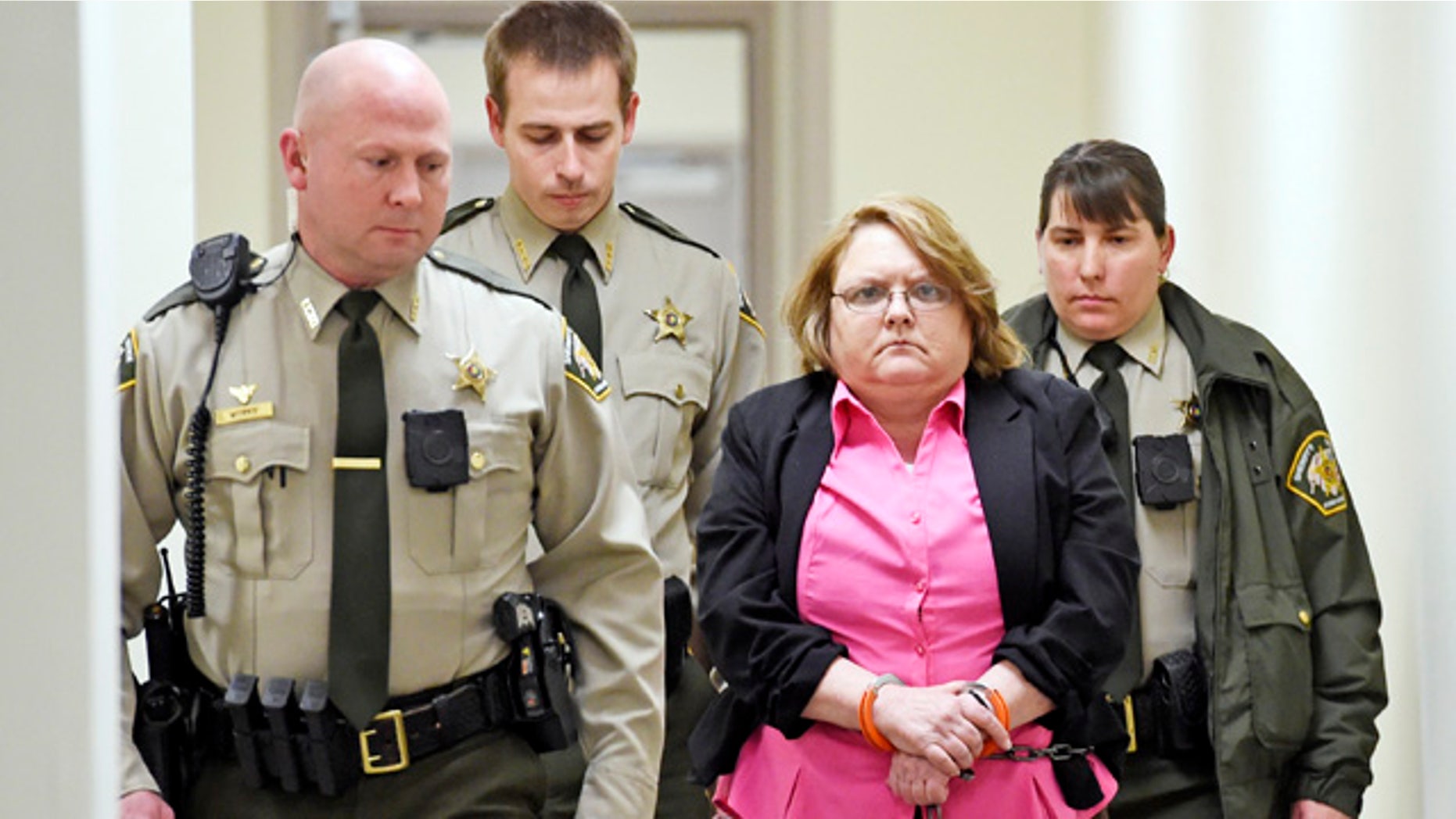 FILE - In this March 20, 2015, file photo, Joyce Hardin Garrard is led back to the Etowah County Detention Center in Gadsden, Ala. (Eric T. Wright/The Gadsden Times via AP, File)