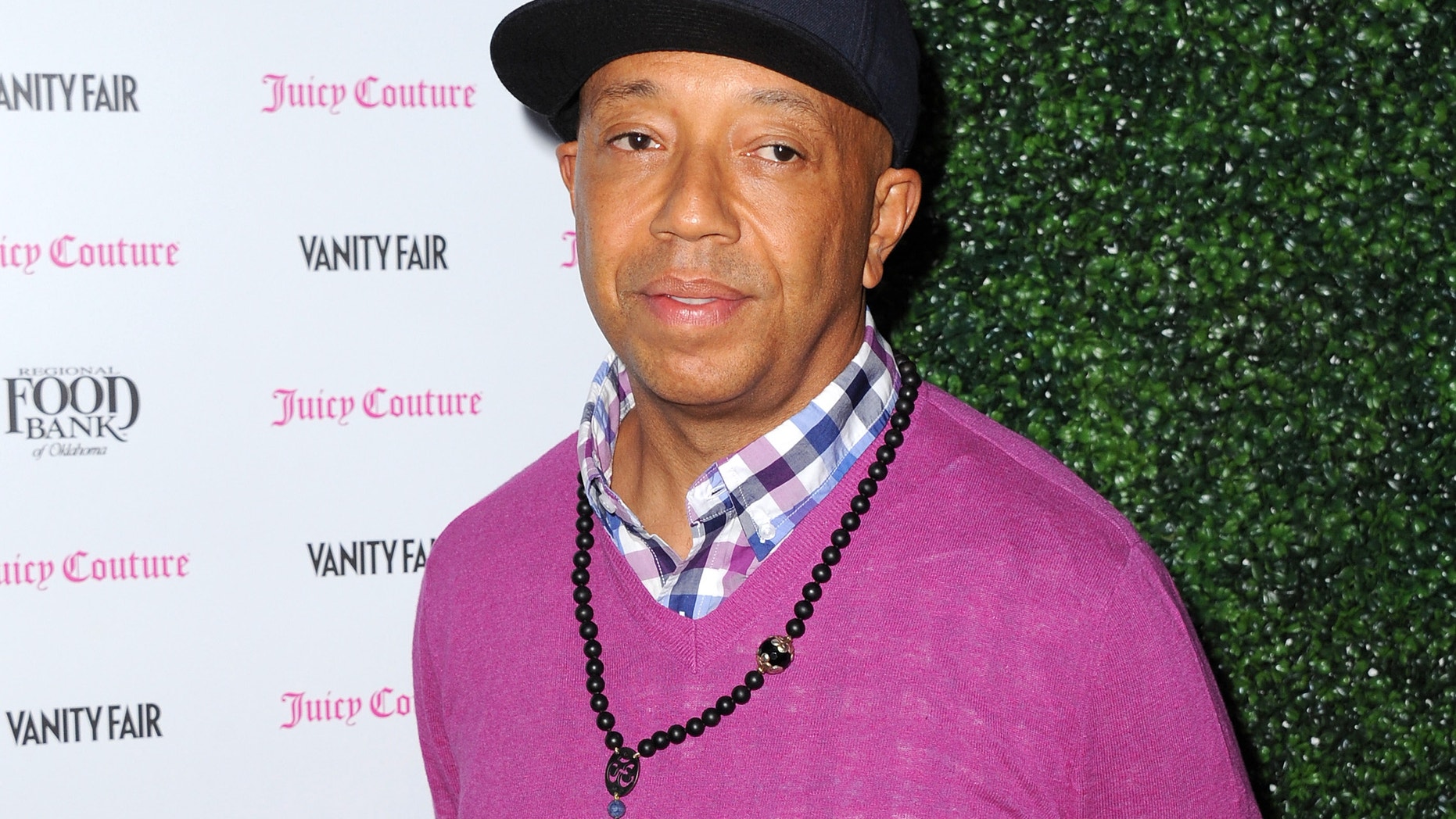 In this Feb. 18, 2013 file photo, Russell Simmons arrives at the Vanity Fair and Juicy Couture Celebration for the 2013 Vanities Calendar in Los Angeles. Simmons is apologizing for a parody video of Harriet Tubman in a sex tape that appeared on his All Def Digital YouTube channel.