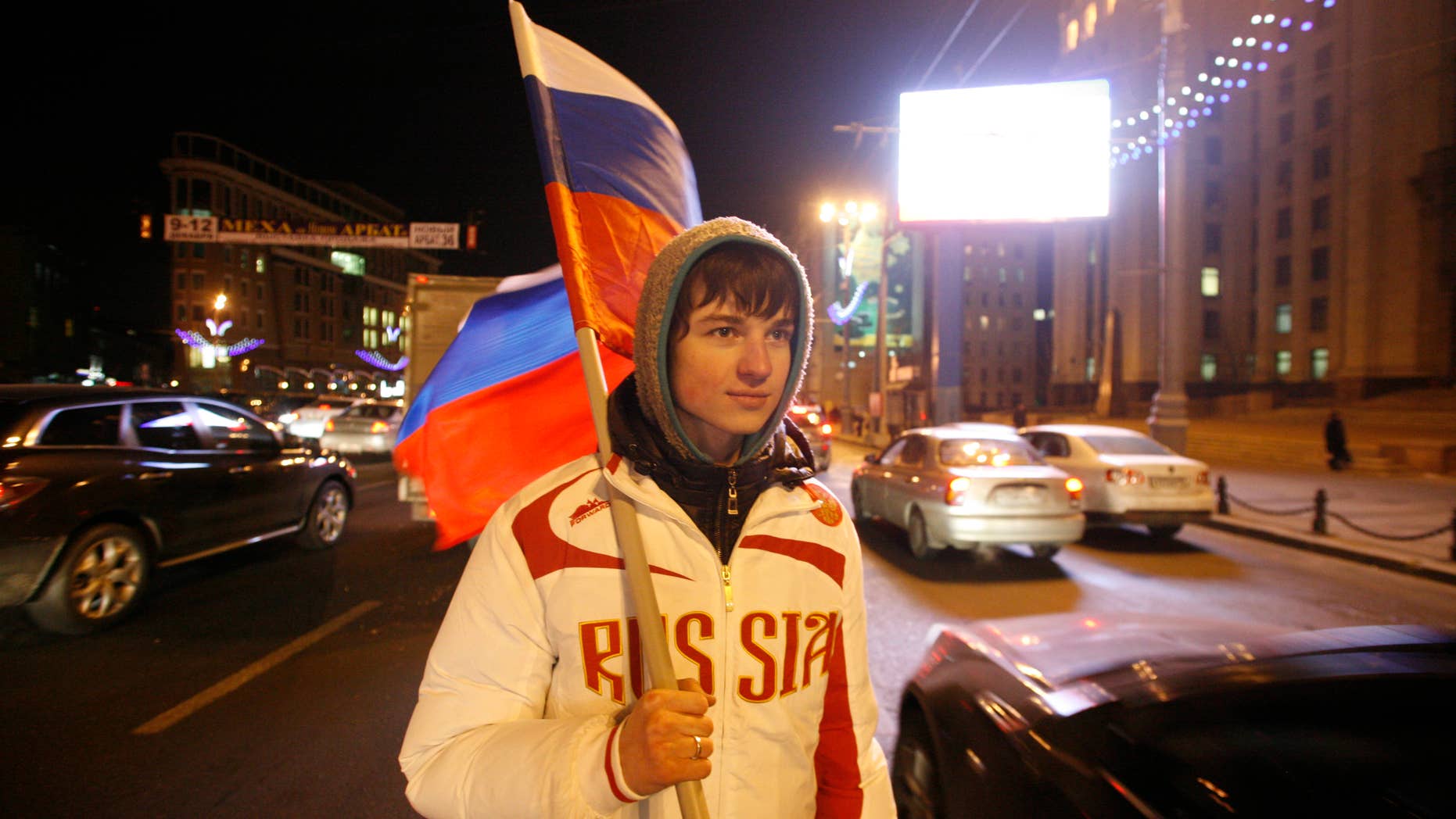 Dec. 2: A young man holding a Russian flag hands out free national flags to motorists in downtown Moscow to celebrate FIFA's selection of Russia as host to the 2018 World Cup.