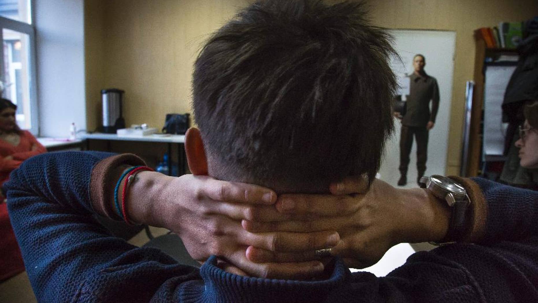 In this photo taken on Tuesday, Feb. 17, 2015, Alevtina sits in LGBT rights group Vykhod center in St. Petersburg, Russia. Alevtina is one of several teachers who lost their jobs in St. Petersburg after being outed by an anti-gay activist. While most resigned quietly, the 27-year-old music teacher decided to fight her dismissal in court _ an unusual step in Russia where gays have faced increasing pressure in recent years. (AP Photo/Dmitry Lovetsky)