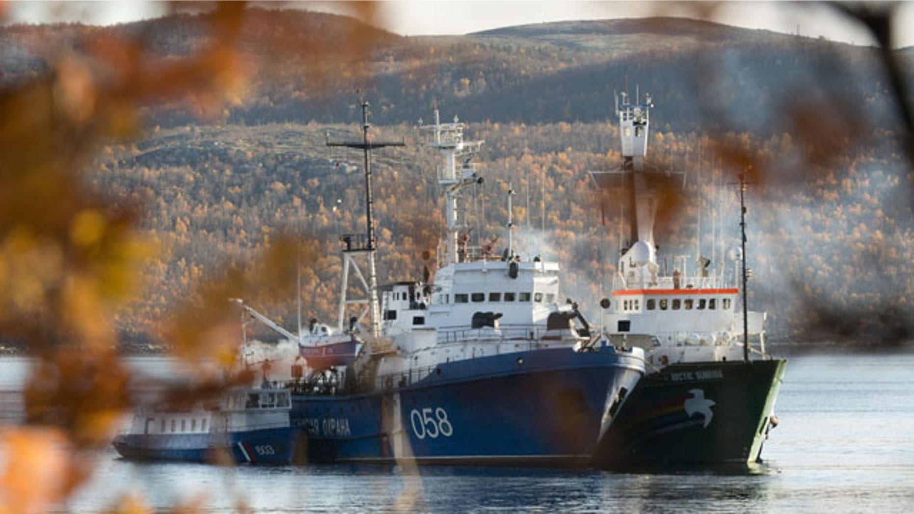October 1, 2013: In this image made available by Greenpeace, the Greenpeace ship, the Arctic Sunrise, right, is anchored side by side with the Russian Coast Guard Ship in the Kolskii gulf, near Murmansk, Russia on Monday, Sept. 30, 2013. (AP Photo)