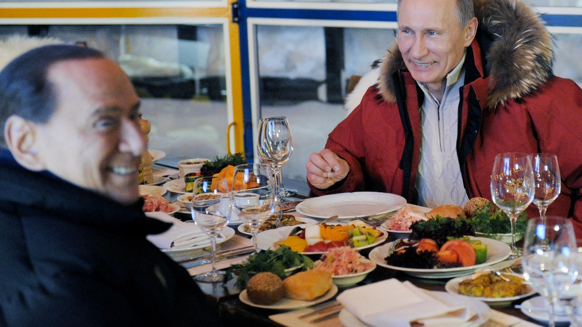 Mar. 7, 2012: Former Italian Prime Minister Silvio Berlusconi, left, and Russian Prime Minister Vladimir Putin, right, smile during their meeting in the mountain resort of Krasnaya Polyana near the Black Sea resort of Sochi, southern Russia.