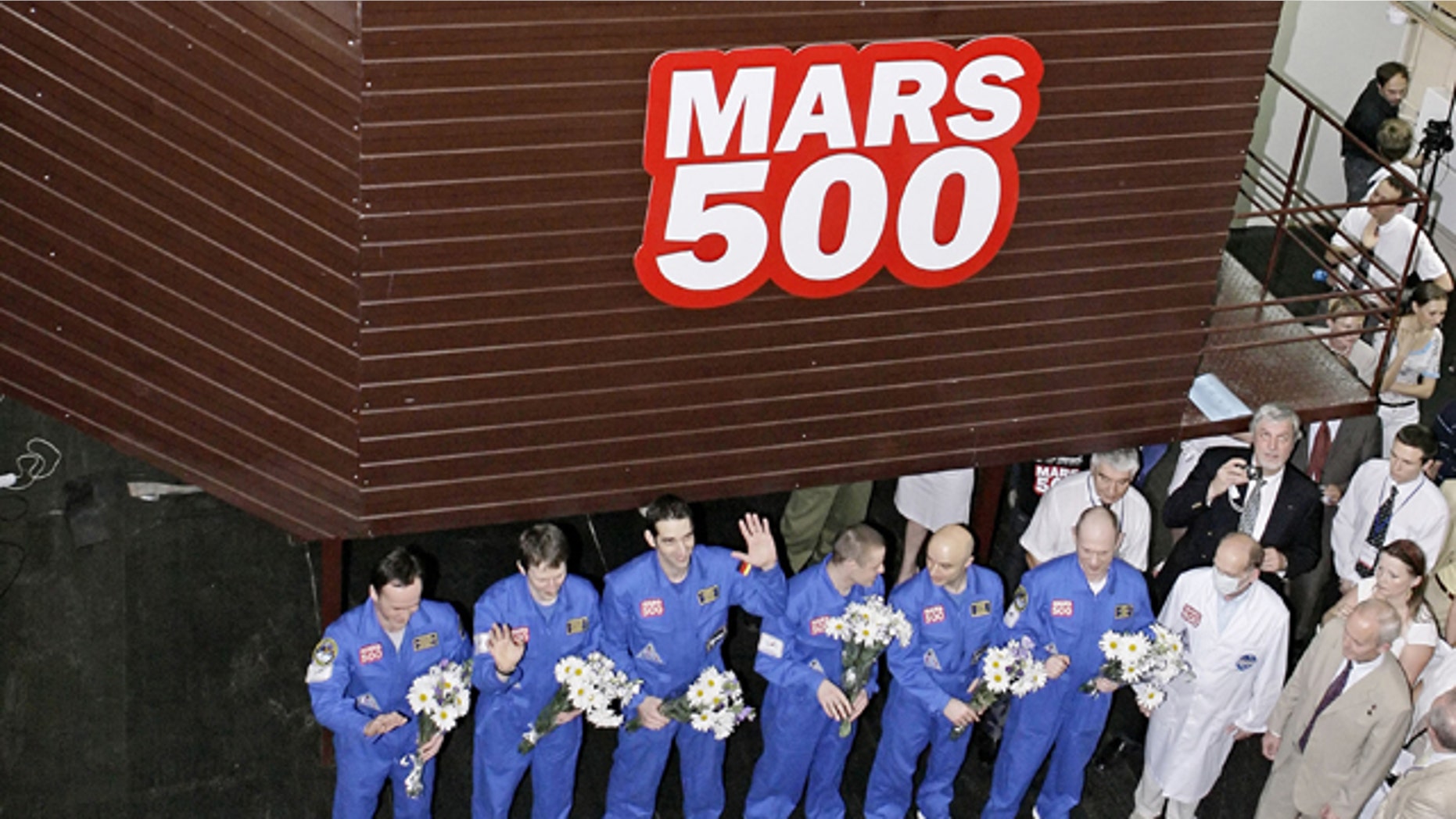 The team of researchers is greeted after ending a three-month simulation mission to Mars at a Moscow research facility, Russia. Another team of researchers will launch a longer, 520-day simulation of Mars mission at the same facility in Moscow on Thursday June 3, 2010.