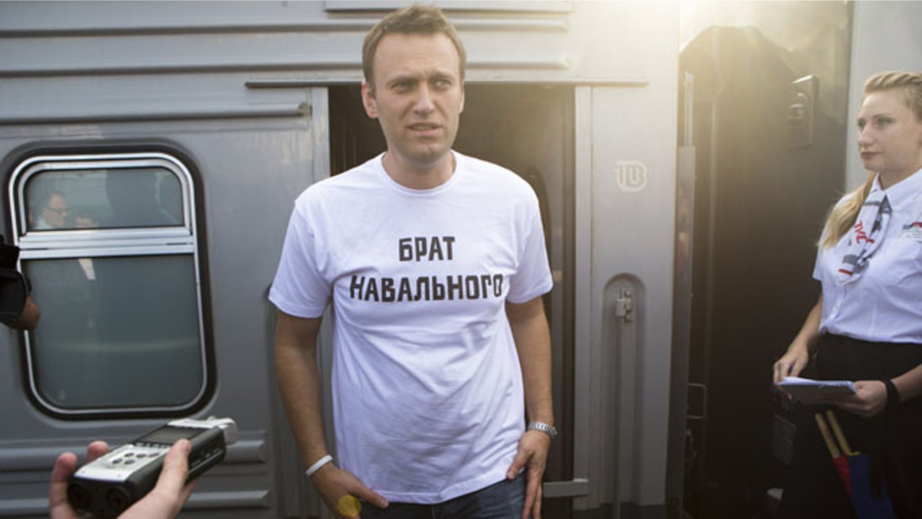 July 17, 2013: Russian opposition activist Alexei Navalny, wearing a T-shirt reading "Navalny's Brother" speaks to supporters and the media at the Yaroslavsky railway terminal in Moscow. (AP Photo/Alexander Zemlianichenko Jr)