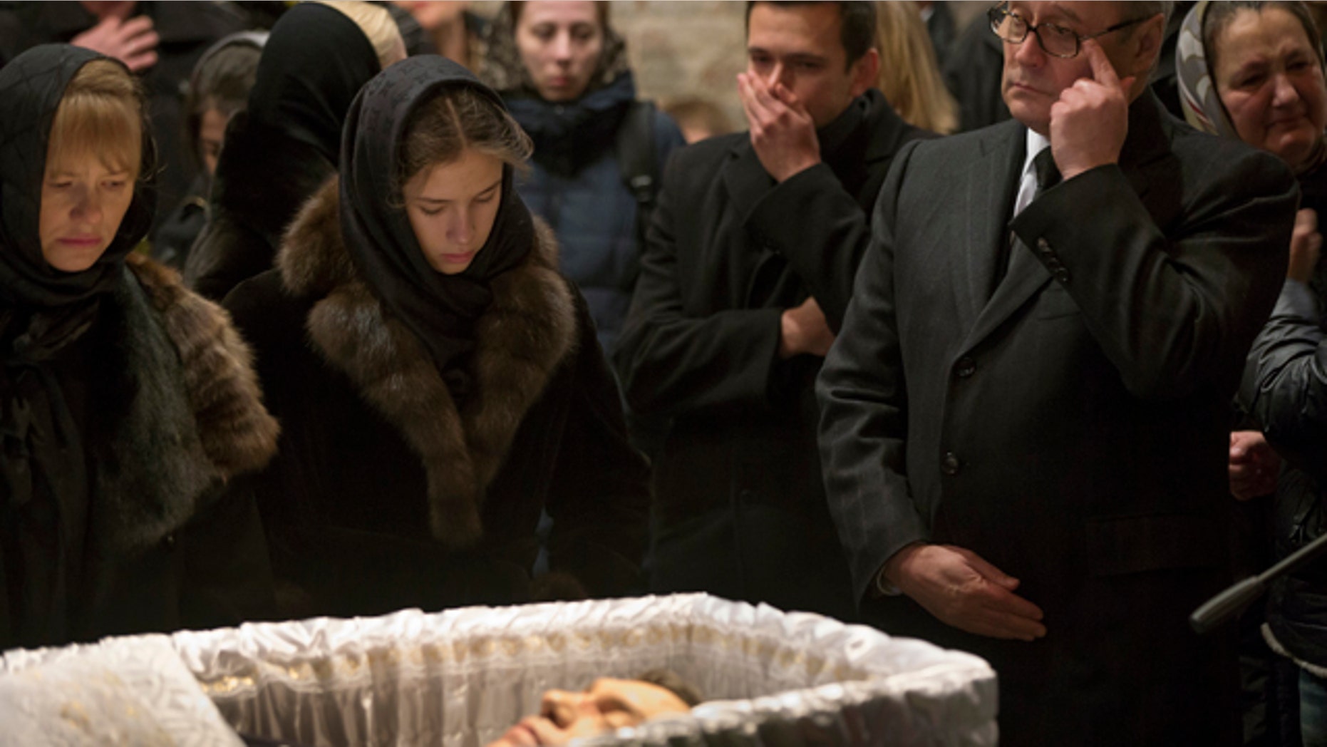 March 3, 2015: Opposition leaders, former Russian Prime Minister Mikhail Kasyanov, right, and Ilya Yashin, second right, and other relatives and friends pay their last respects by the coffin of Boris Nemtsov, a charismatic Russian opposition leader and sharp critic of President Vladimir Putin, during a farewell ceremony inside the Sakharov center in Moscow. (AP Photo/Pavel Golovkin)