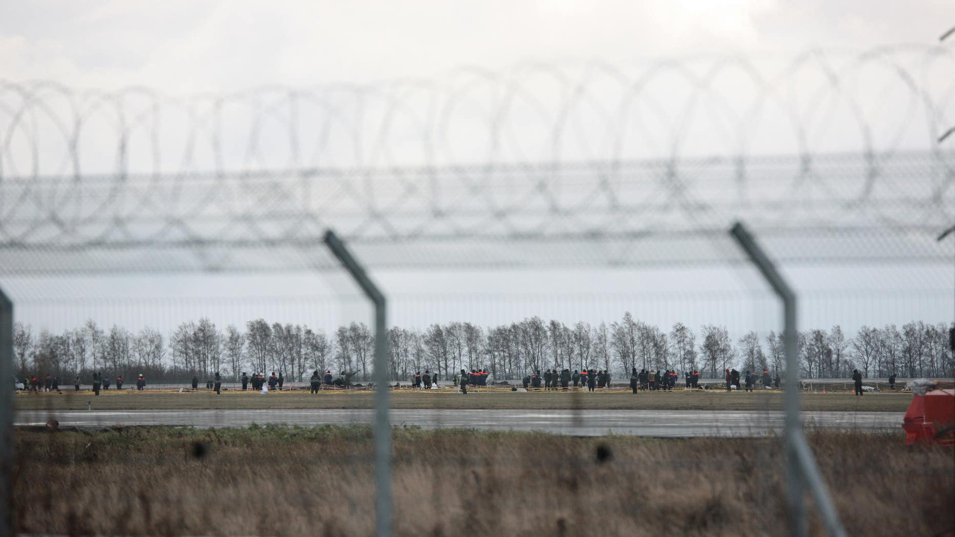 Nov. 18, 2013 - Officials and investigators search a plane crash site in Kazan airport. The plane belonging to Tatarstan Airlines crashed Sunday while trying to land at its home port in the Russian city of Kazan.