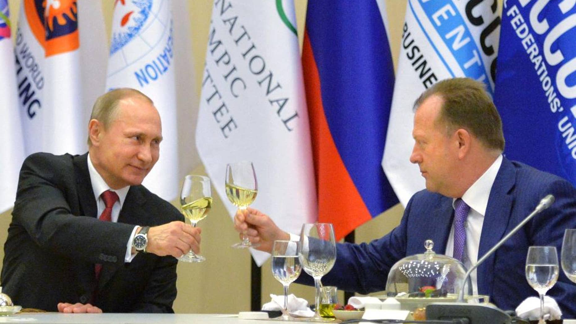 Russian President Vladimir Putin, left, toasts with Marius Vizer, head of IFJ and SportAccord Convention president, during a reception in Russian Black Sea resort of Sochi, Russia, Monday, April 20, 2015. (Alexei Druzhinin/RIA Novosti, Kremlin Pool Photo via AP)